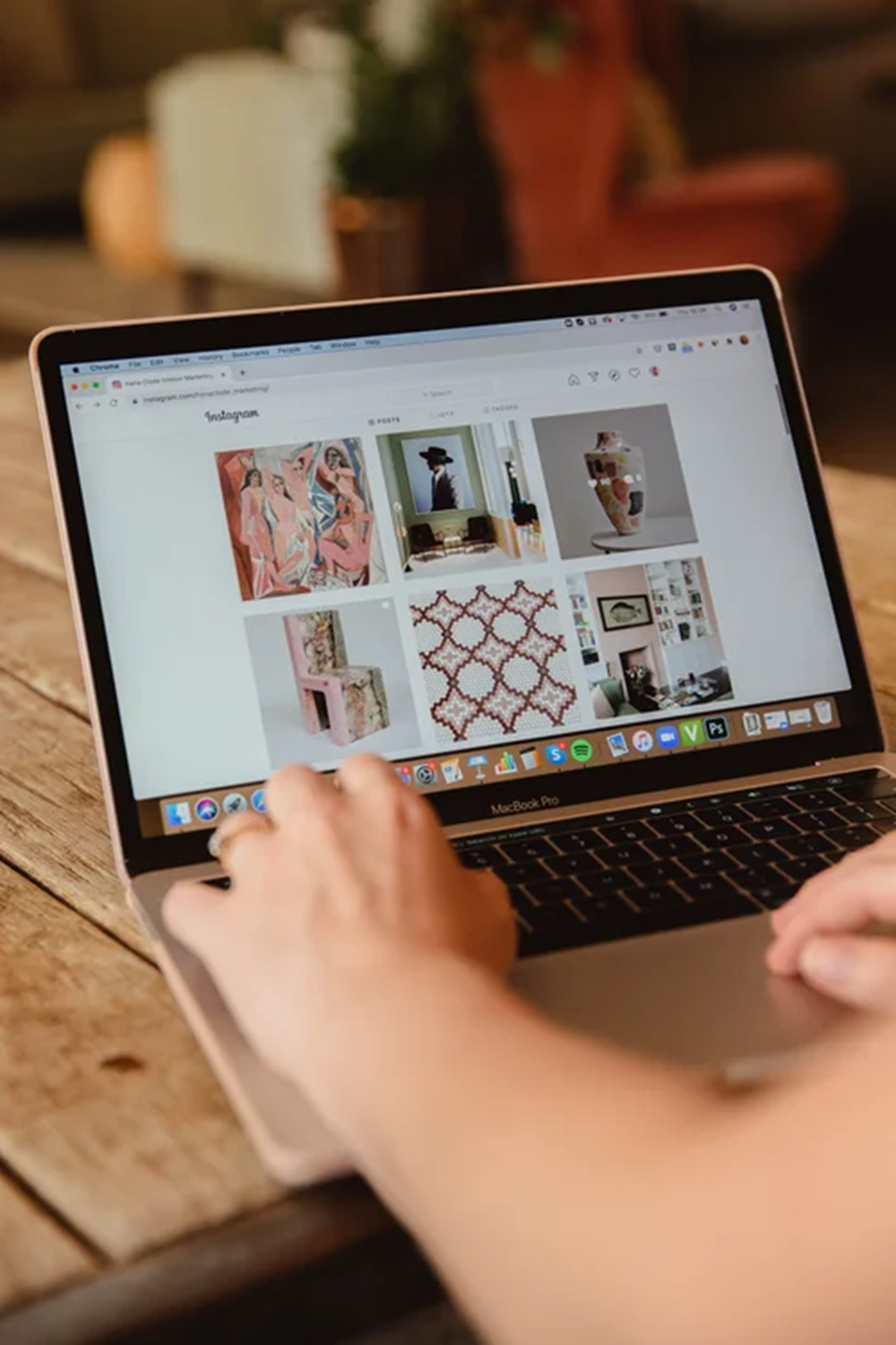 Laptop displaying an interior design Instagram feed during digital marketing work