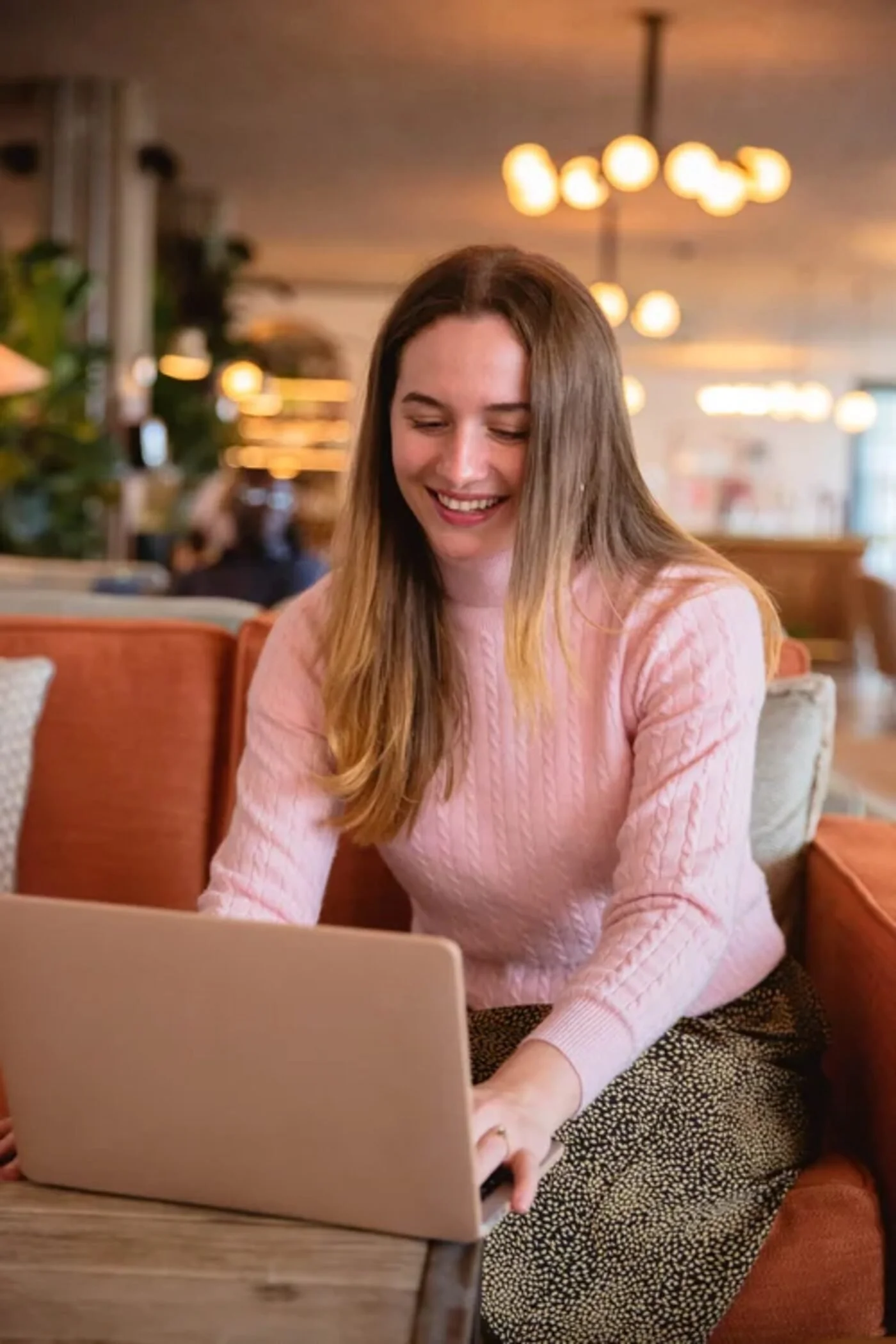 Hana Clode working on a laptop as an interiors marketing consultant