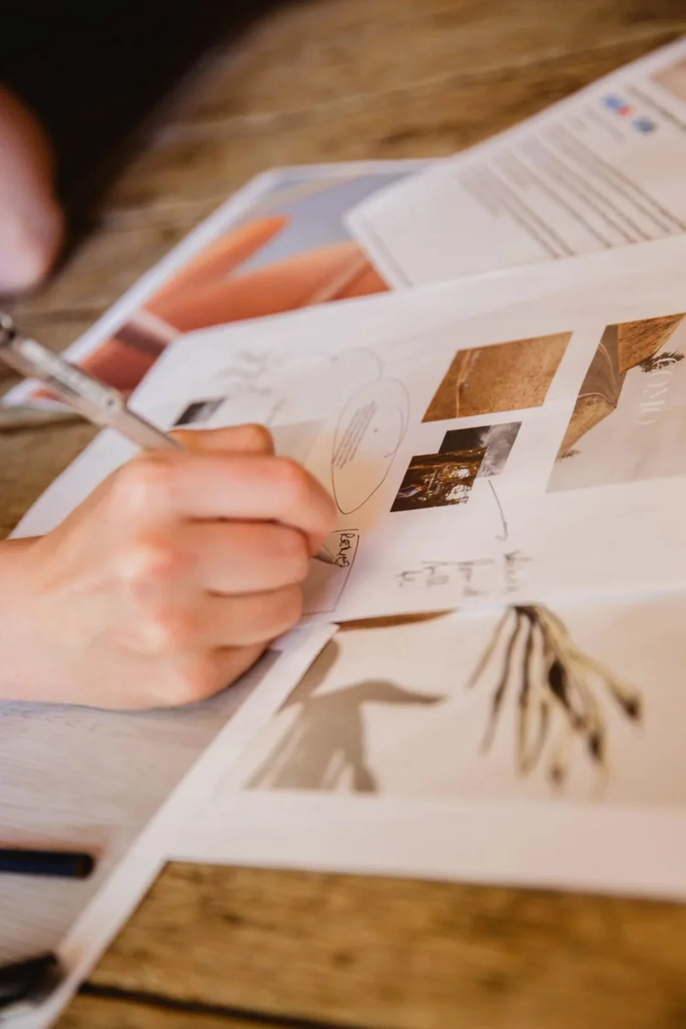 Marketing strategy planning with printed interior design imagery and handwritten notes