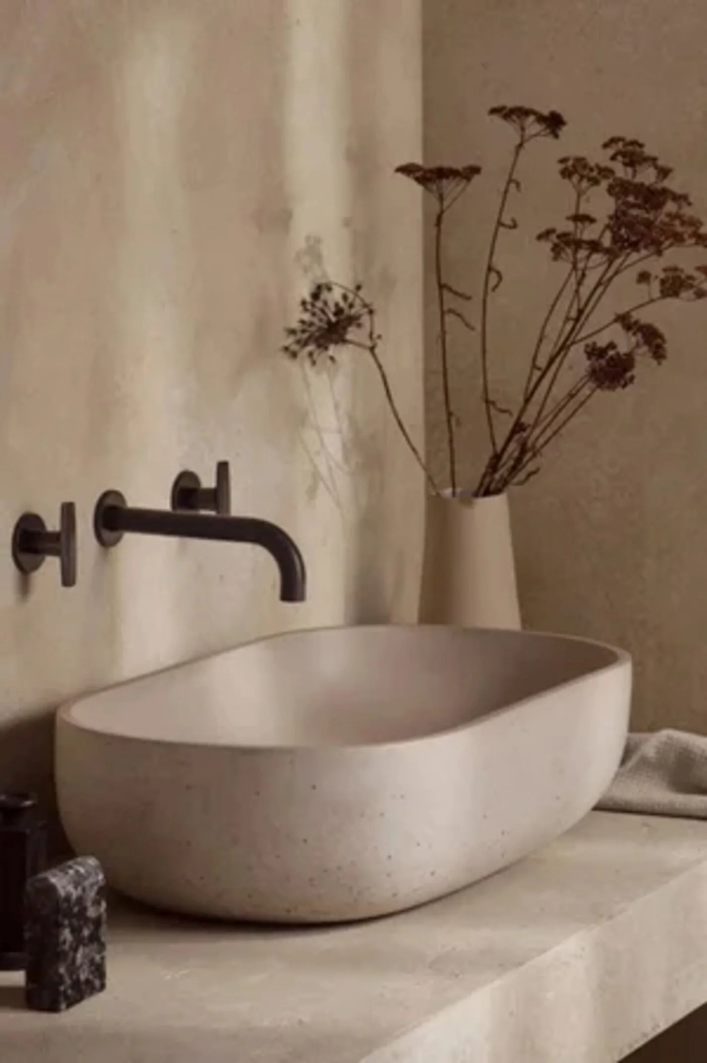 Bathroom interior featuring a stone basin and wall-mounted Samuel Heath brassware