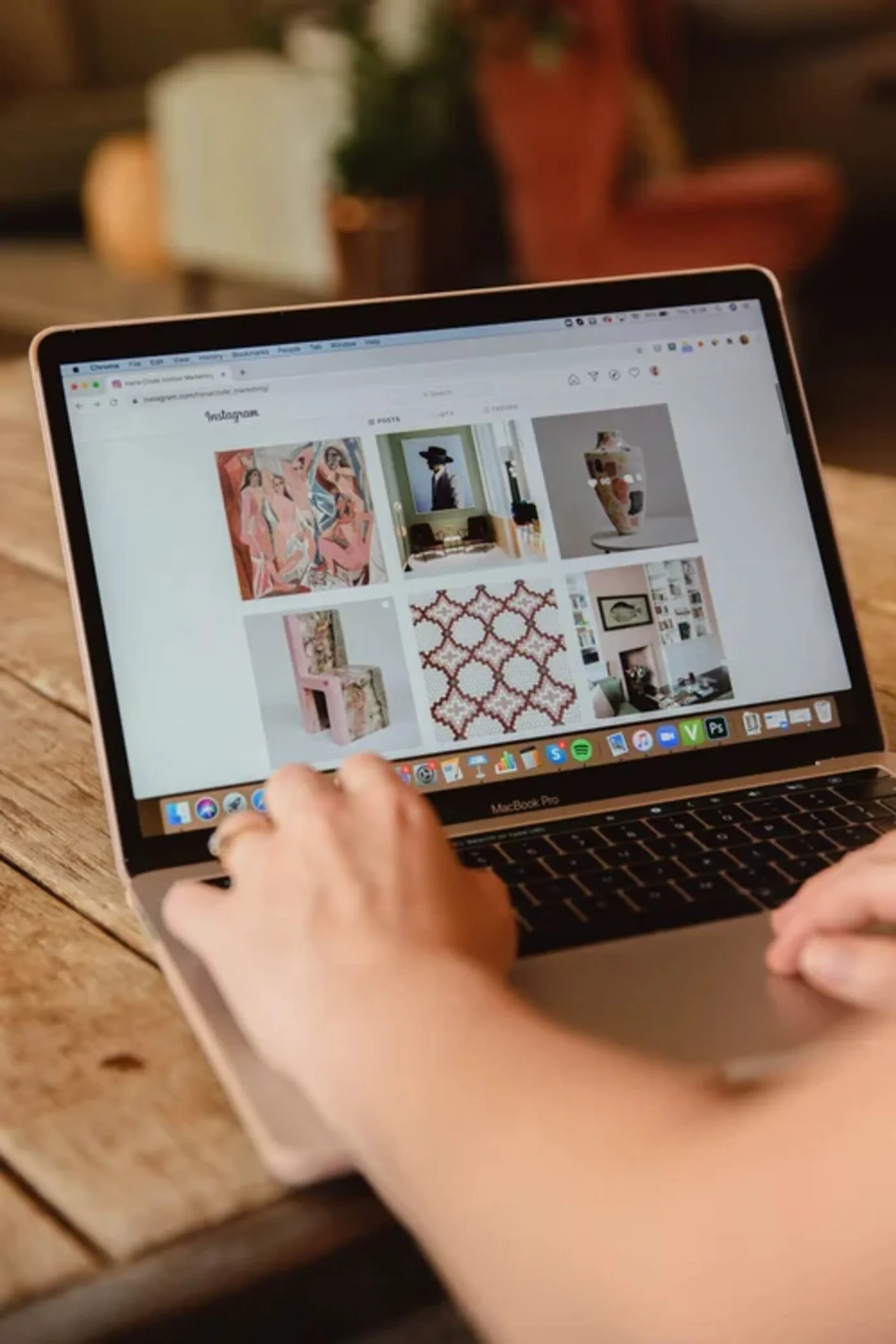 Laptop displaying an interior design Instagram feed during digital marketing work