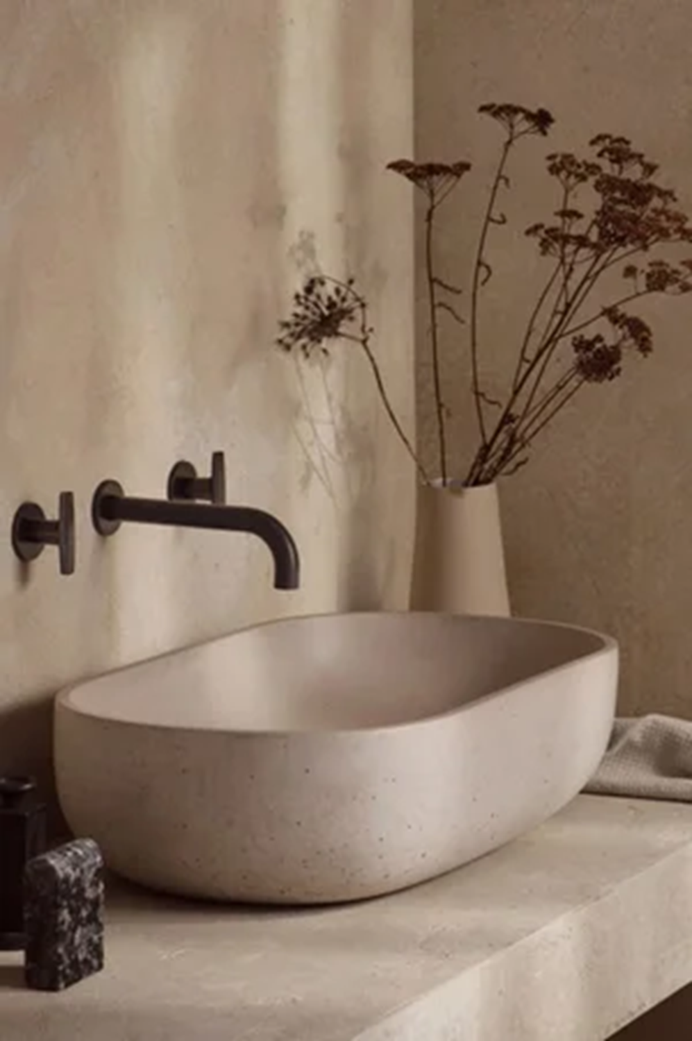 Bathroom interior featuring a stone basin and wall-mounted Samuel Heath brassware