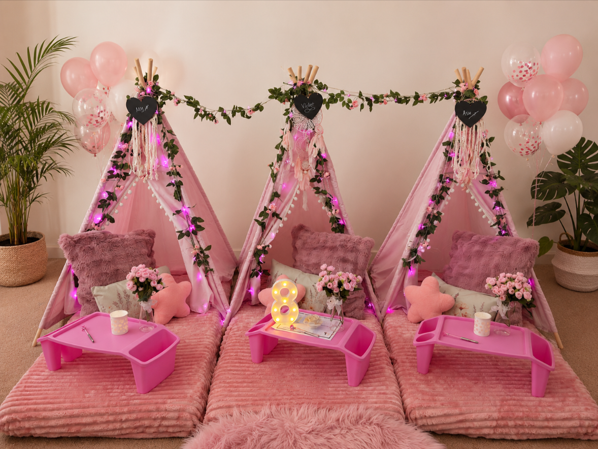 Pink teepee slumber party set-up with fluffy cushions, blankets and rugs. Decorative balloons and flowers.  Teepee slumber parties Geelong.