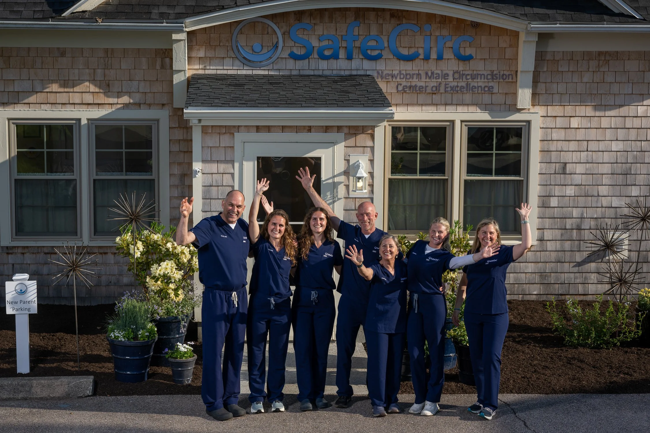 Safecirc team in blue uniforms standing in front of their medical office