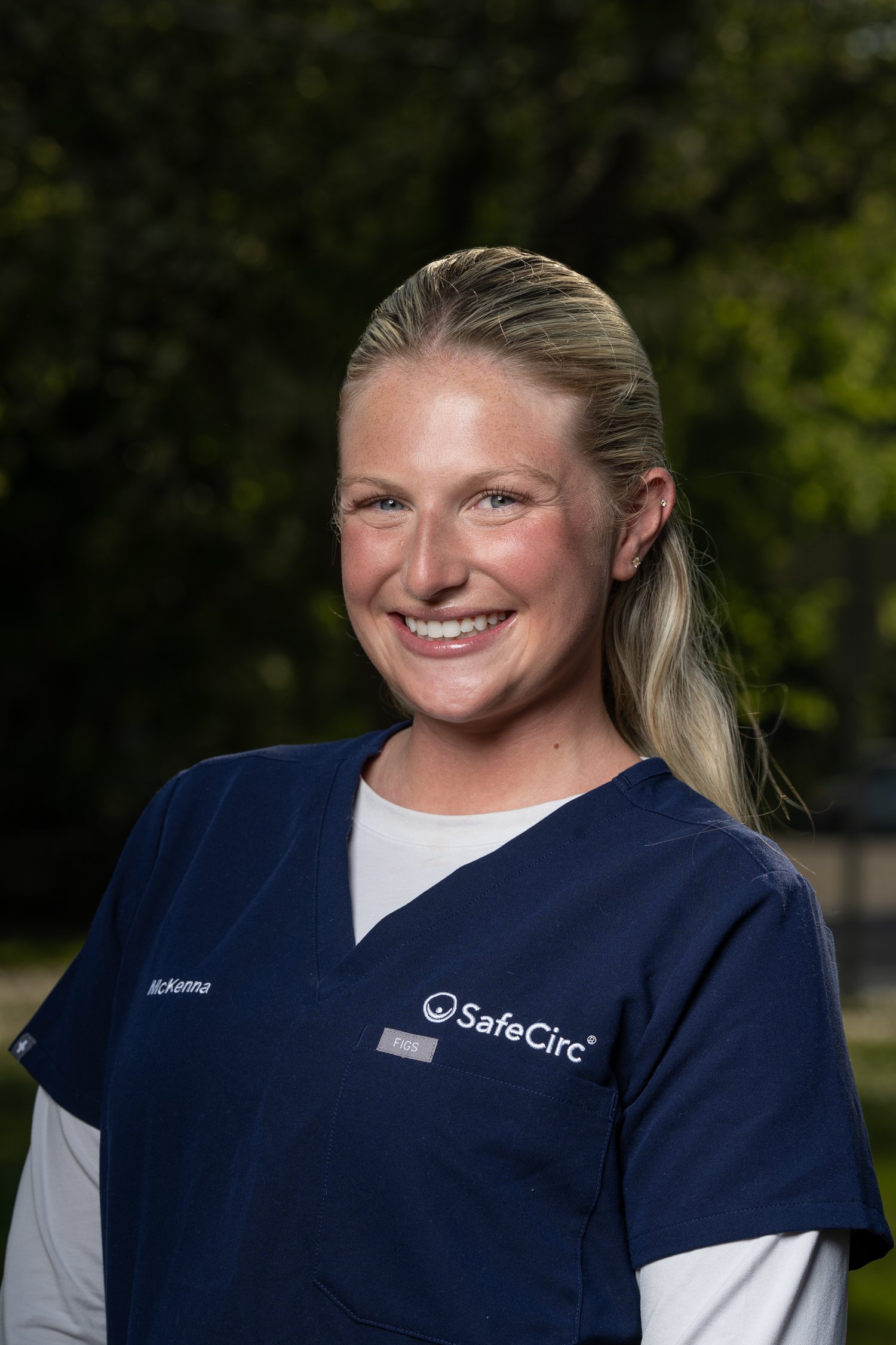 Headshot of McKenna Cahill, BSN, RN Candidate wearing a navy blue medical scrub top with SafeCirc logo