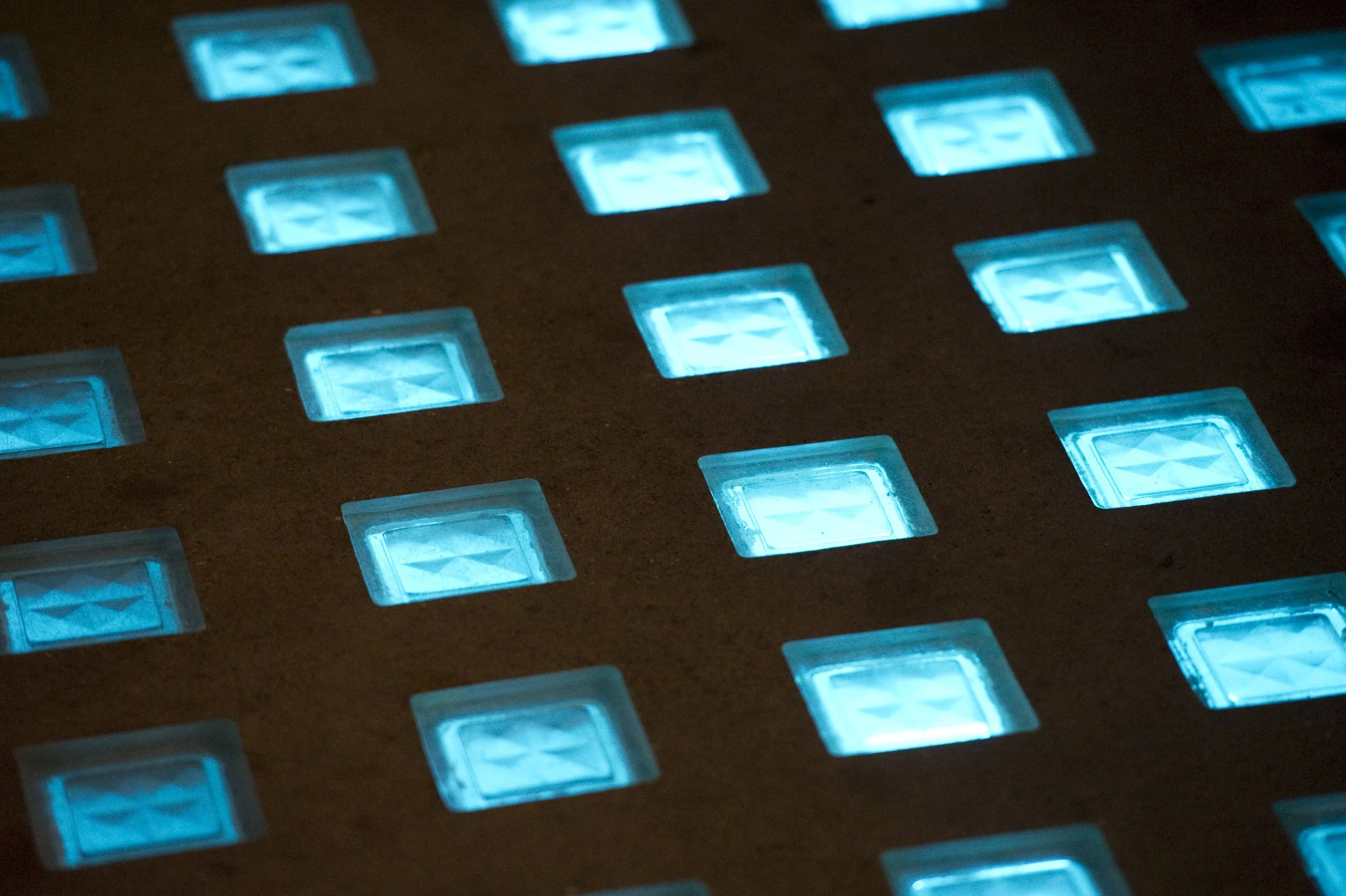 Close-up of a grid of blue LED lights on a dark surface. Marchmont Community Centre