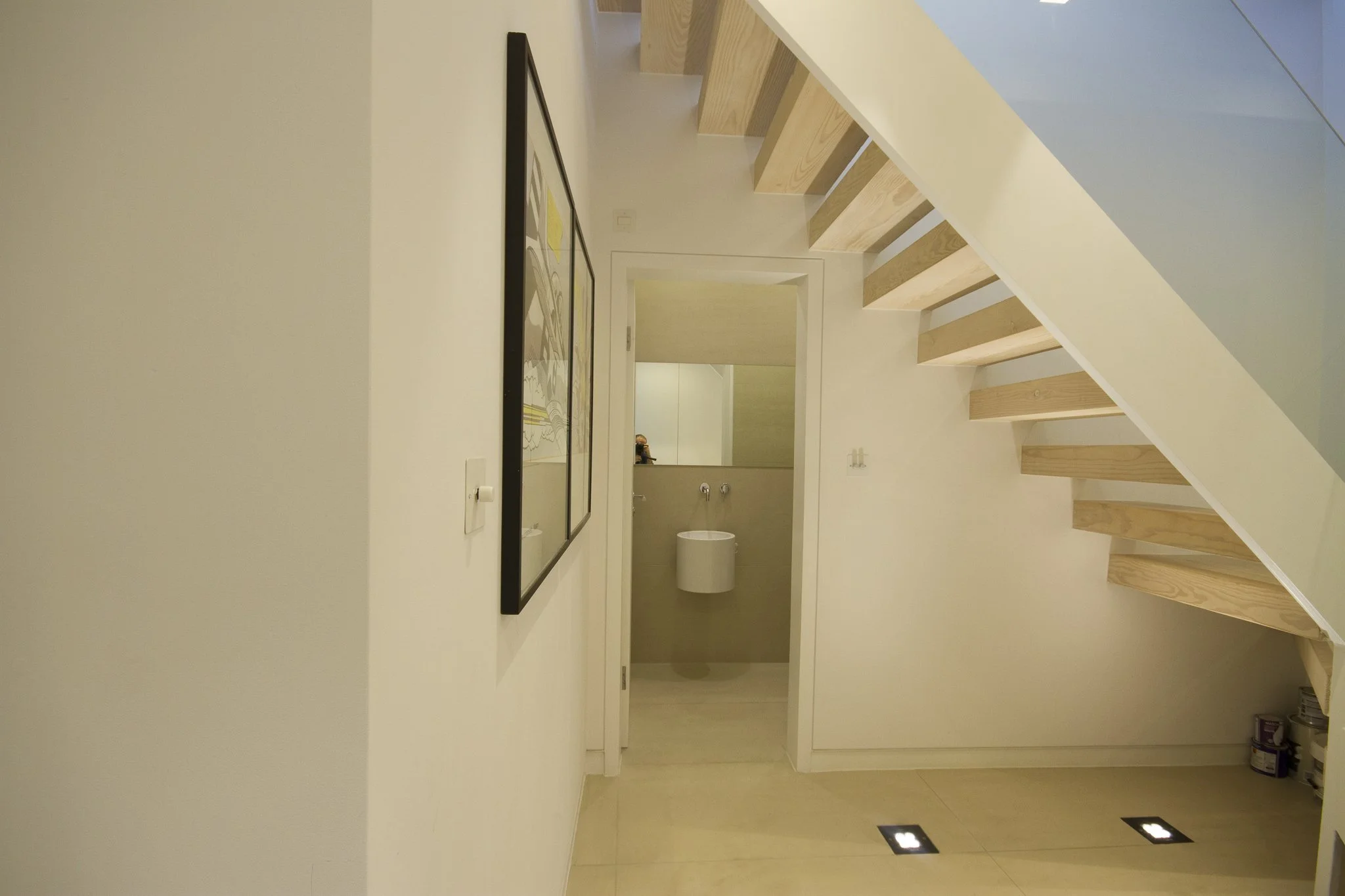 Interior view of new staircase from lower ground to ground floor and the new toilet with a sink and toilet in the background. Sutherland Avenue, Maida Vale