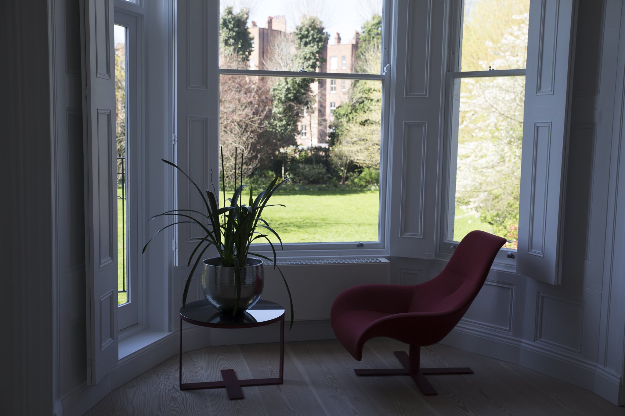 A room with a large window overlooking the rear garden of the refurbishes and extended house in Sutherland Avenue, Maida Vale
