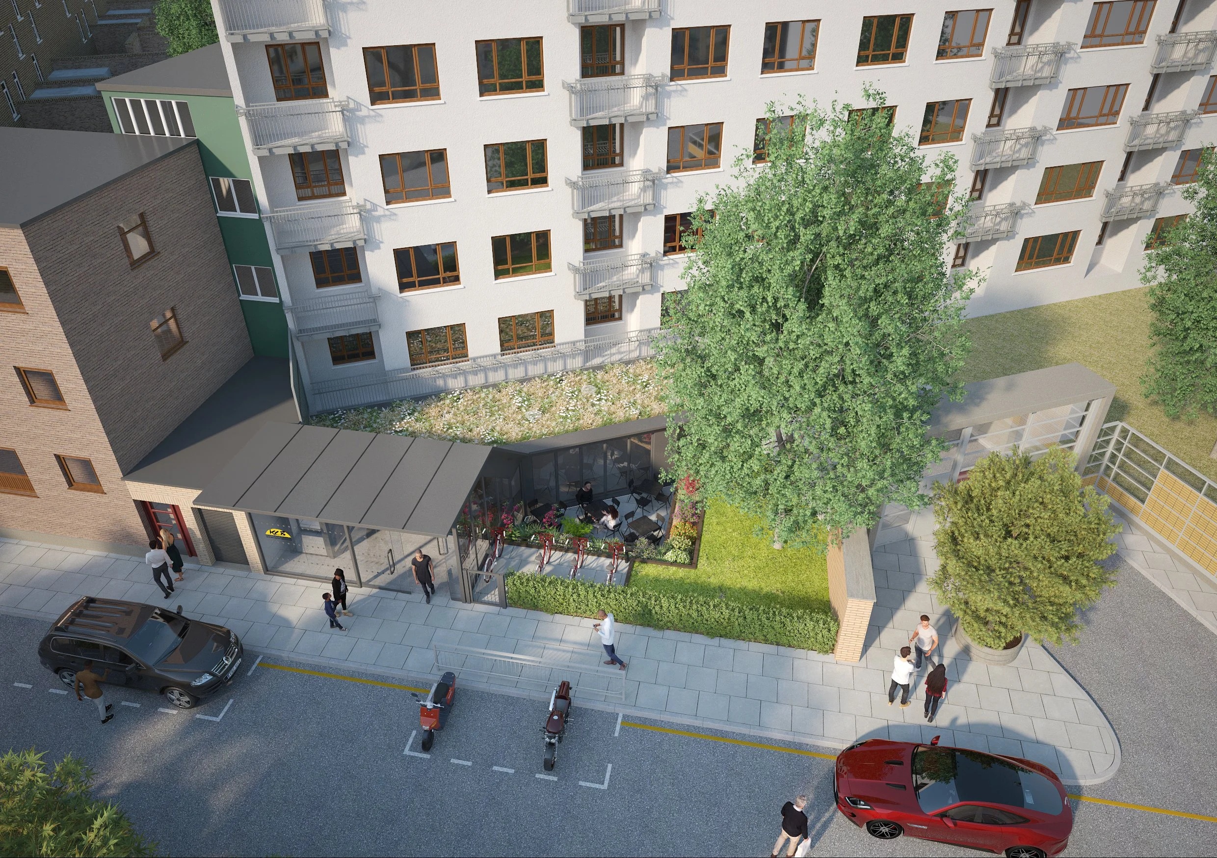 An aerial view of a modern front extension of the community centre with white and brick facade, a small outdoor seating area with table and chairs. Kings Cross Community HUB