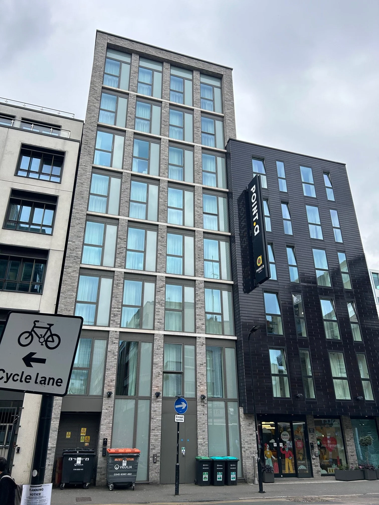 Tall modern front facede with large glass windows and brick finish of the The Point A Hotel in Shoreditch