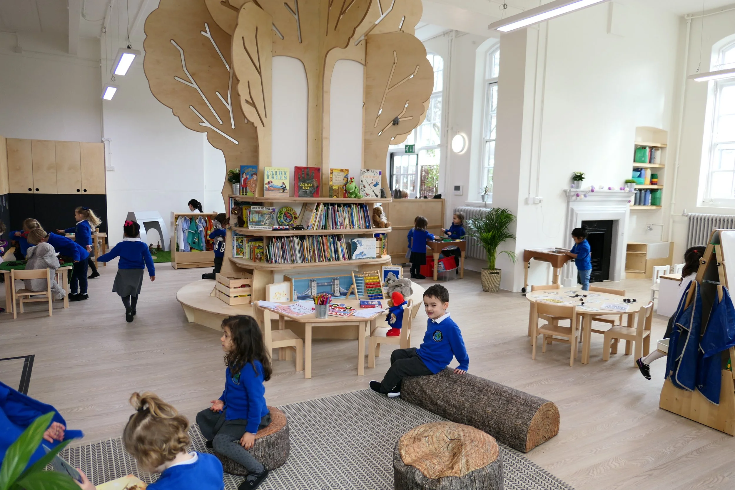 Children nursery with bespoke large tree like design bookshelf as the center focal point, the school is designed with the Montessori principles in mind. 