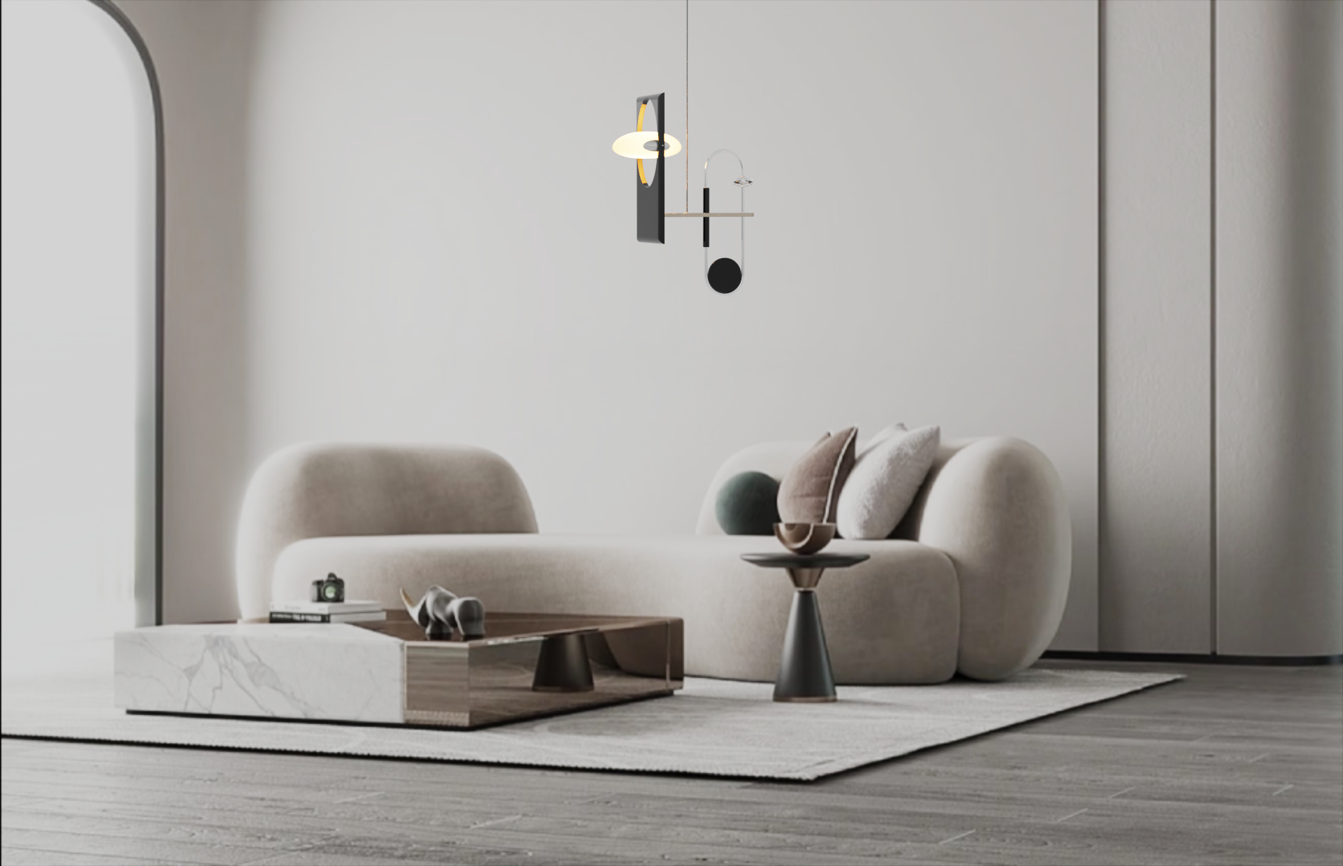 Modern living room with a beige curved sofa, throw pillows, round side table, abstract sculpture, and wall-mounted modern lamp.