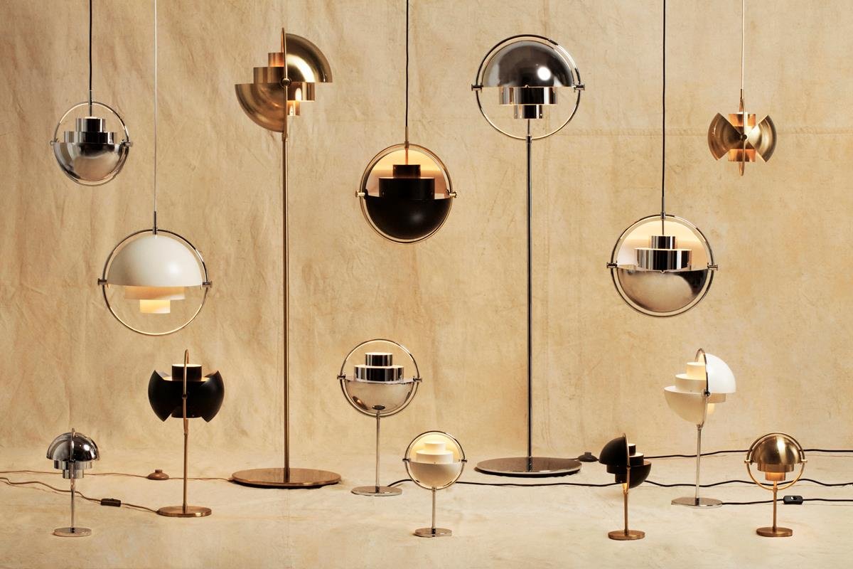 Collection of modern, decorative pendant lamps with metallic and white finishes, arranged against a neutral background.