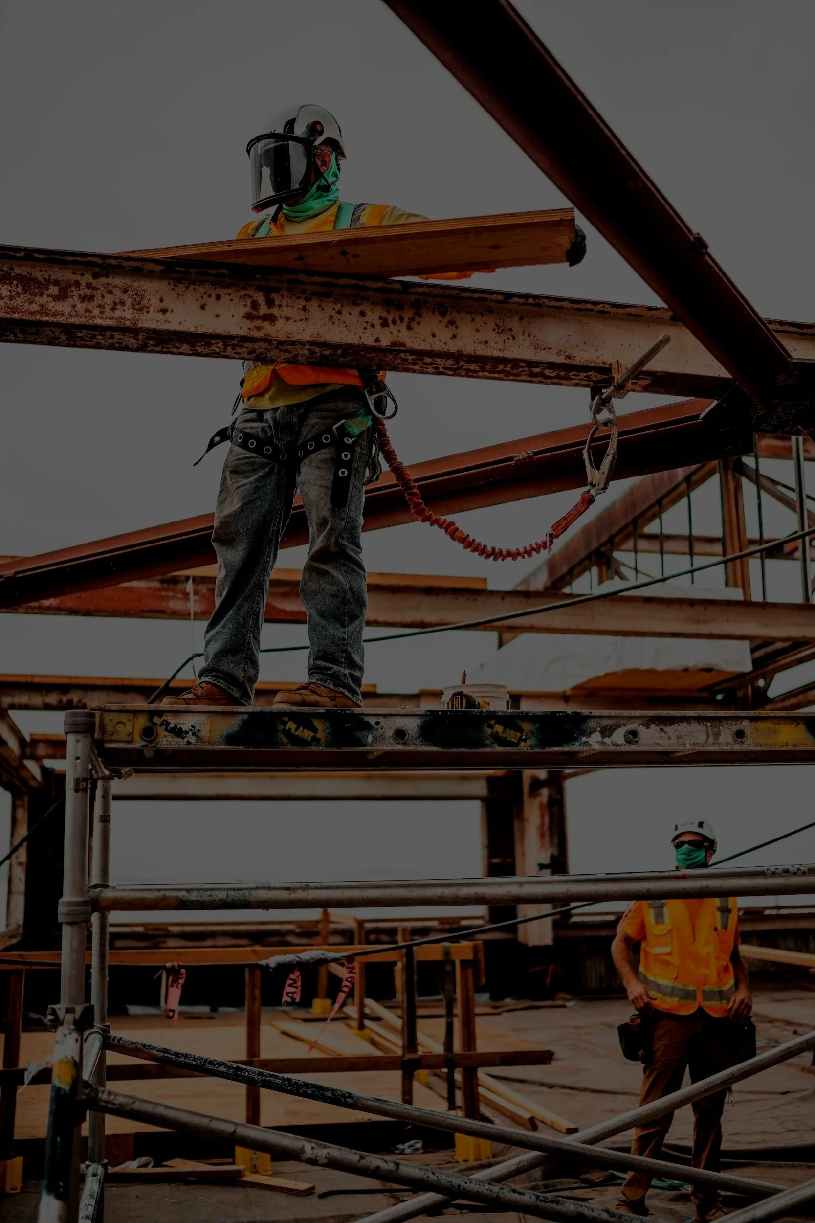 Oranssi technician working on a roof project