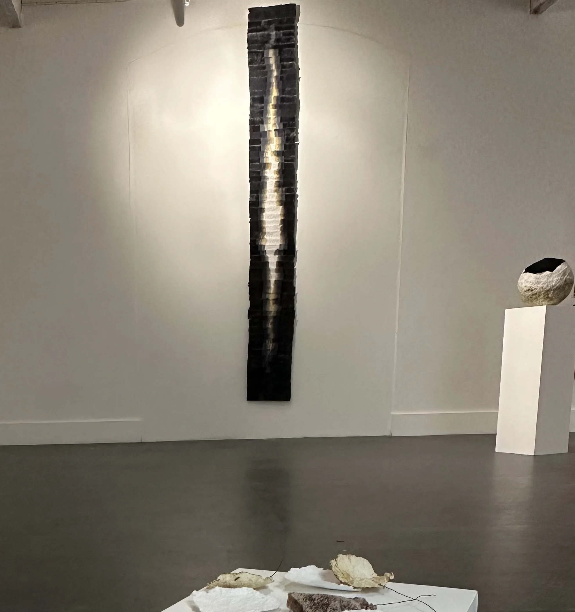 Rupture II, 2026. Handmade cotton rag paper, iron gall ink, cotton ​ and waxed linen thread. Dimensions 21 x 241 cm. Installation view.​