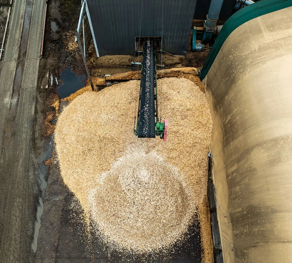 aerial view of wood chips coming out on a conveyor belt