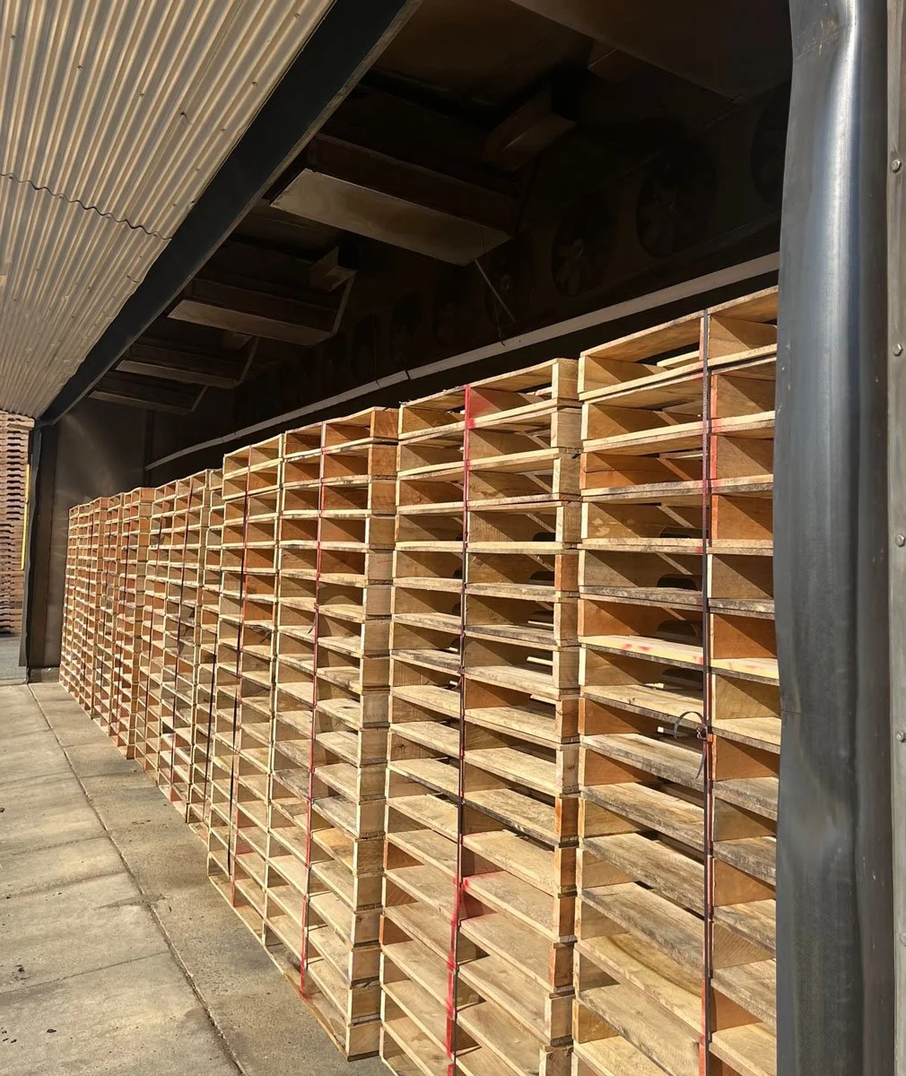 Wood pallets stacked inside of a wood heat treater
