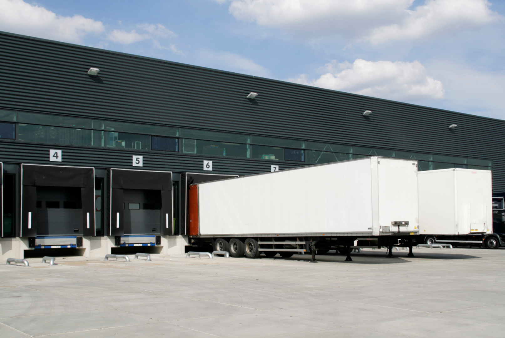 Loading docks at a warehouse with trucks and trailers