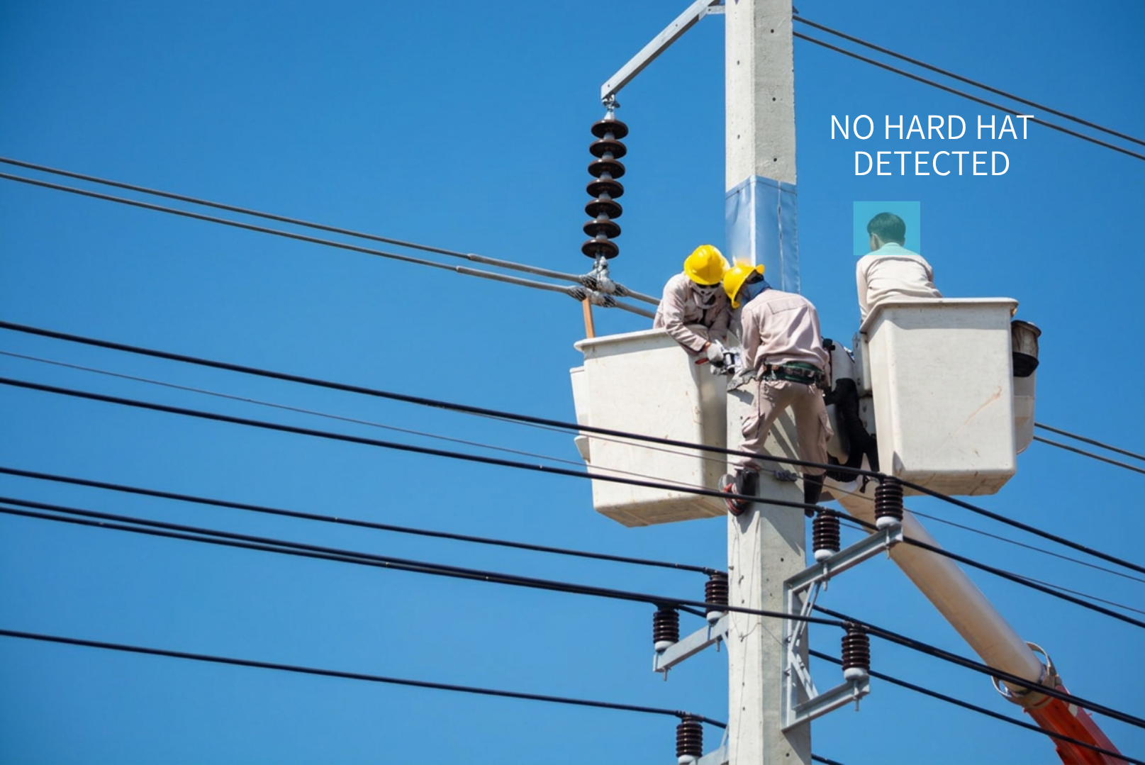Three utility workers in safety gear working on electrical power lines from a bucket truck against a clear blue sky, with text indicating "NO HARD HAT DETECTED".