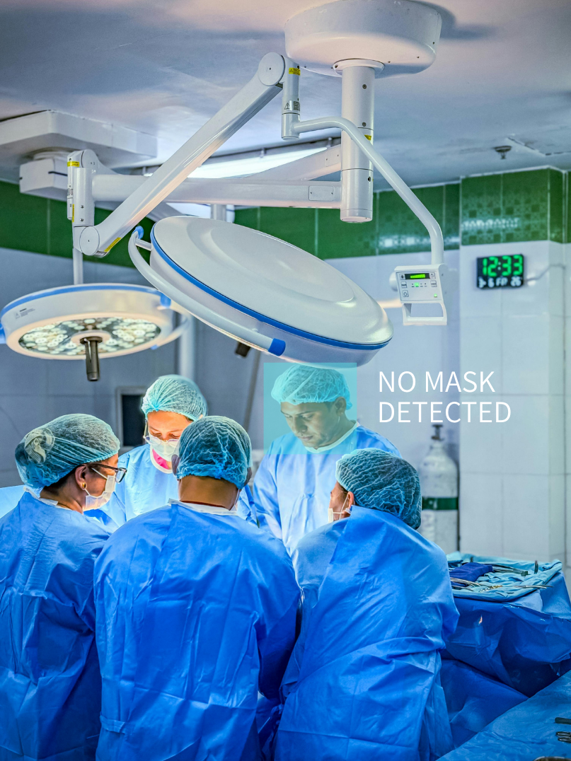 Medical team performing surgery in an operating room, with hospital-grade lights overhead, and a digital clock on the wall showing 12:33. Text overlay says 'NO MASK DETECTED'.