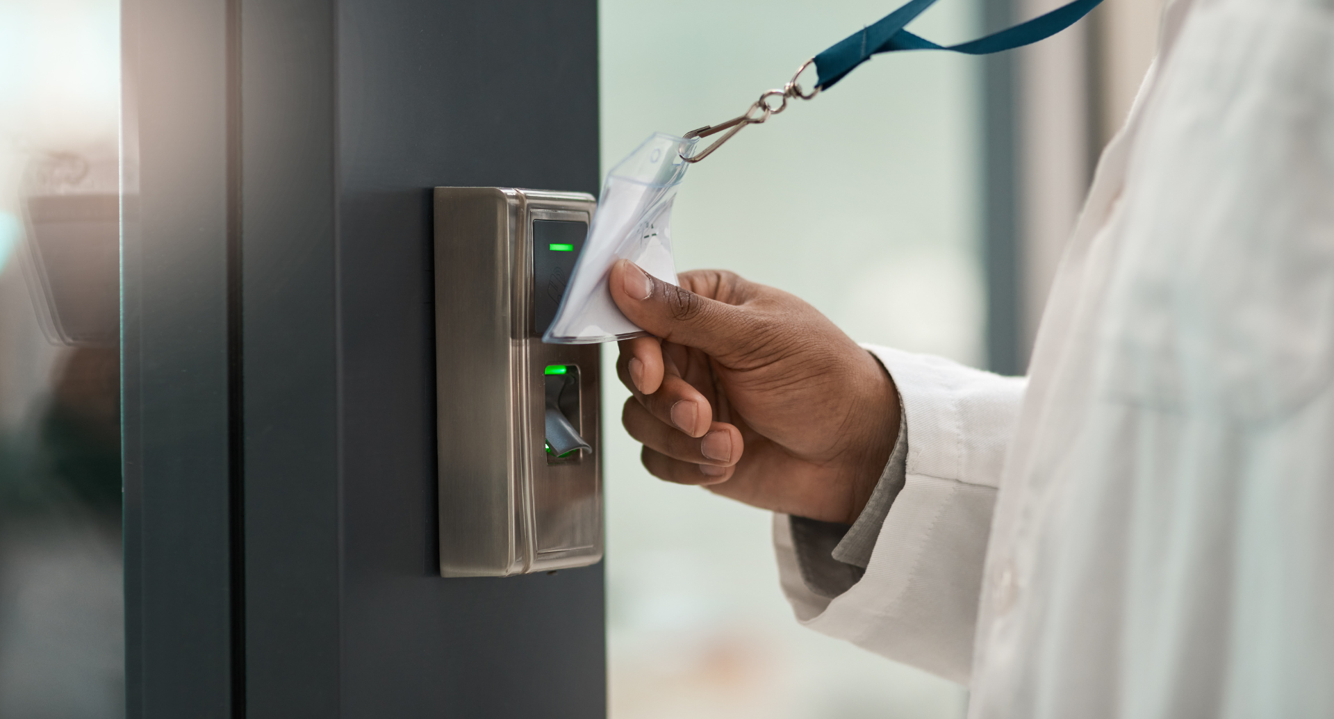 Person using an ID card to access a secure area with a card reader scanner.