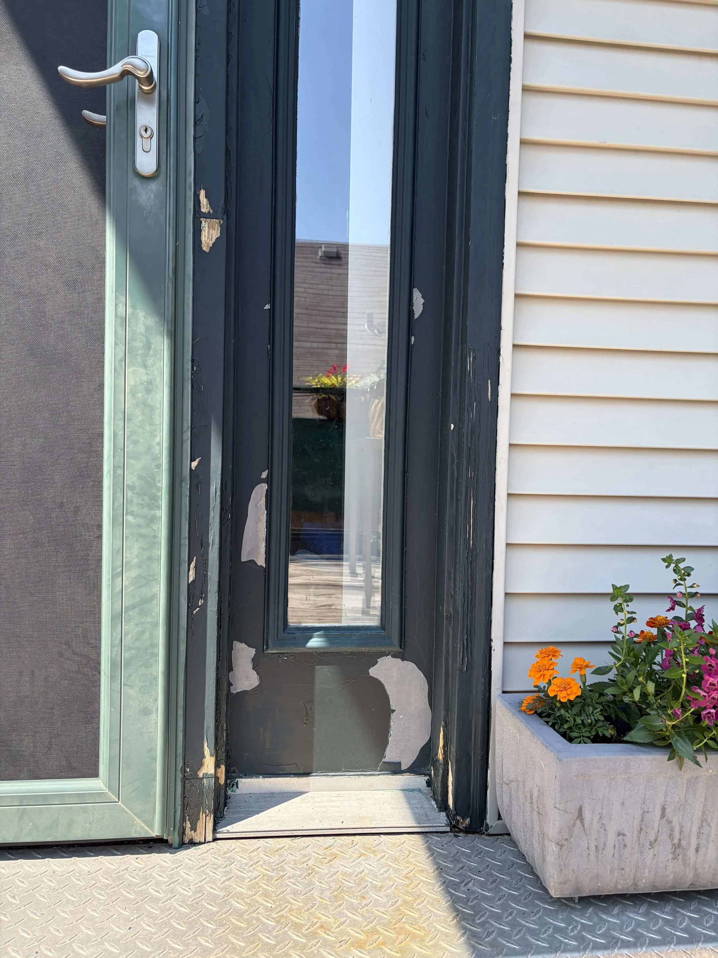 Green front door in Forest Park with peeling paint