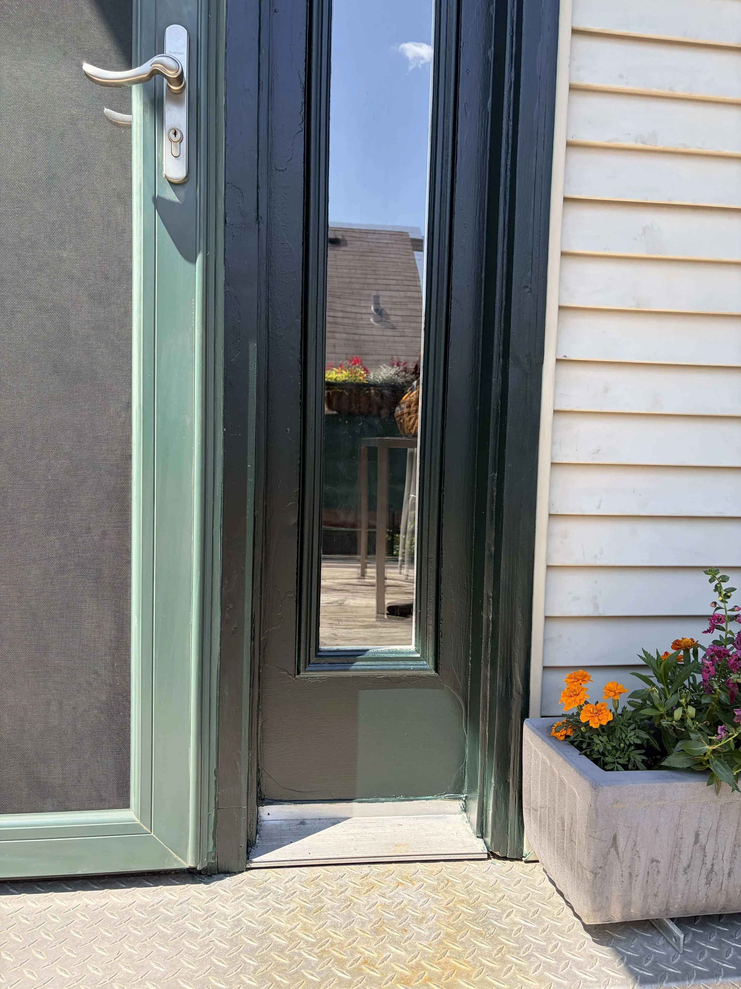Green front door in Forest Park freshly painted by handyman