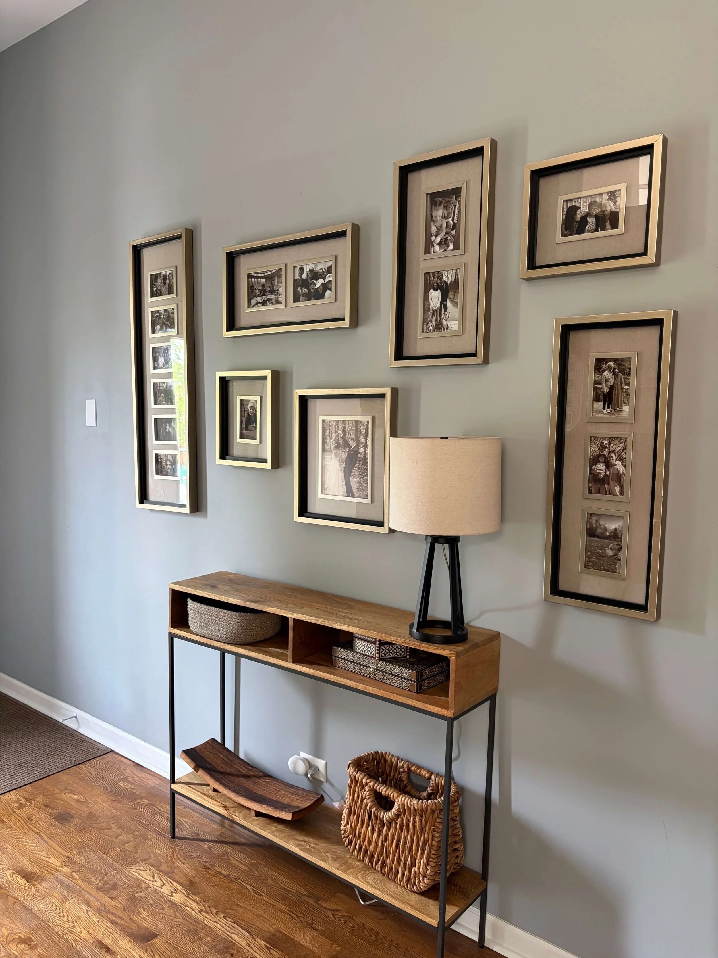 Entryway in Forest Park home with entryway table, lamp, and newly hung gallery wall done by handyman