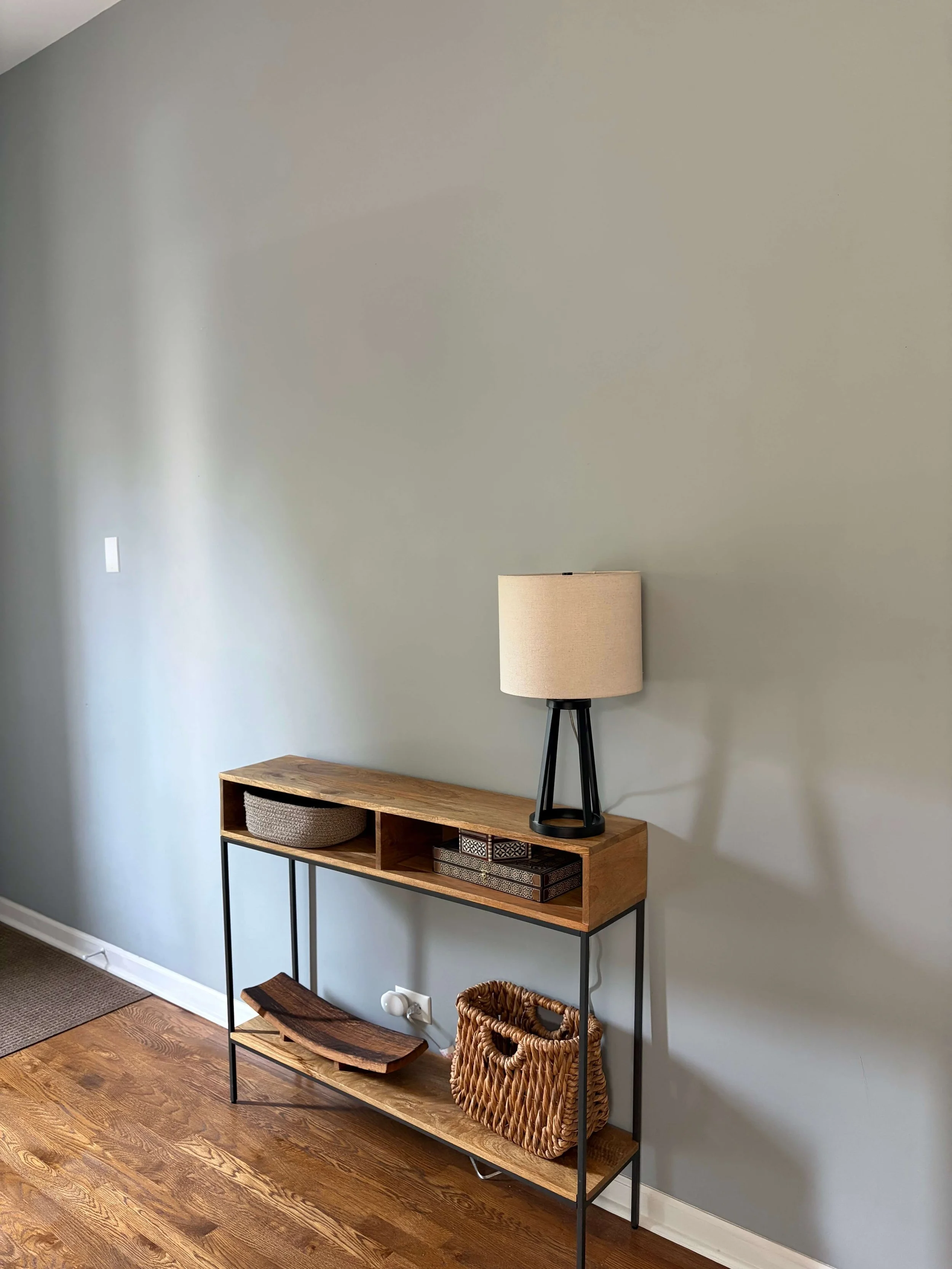 Entry way table with lamp and empty wall