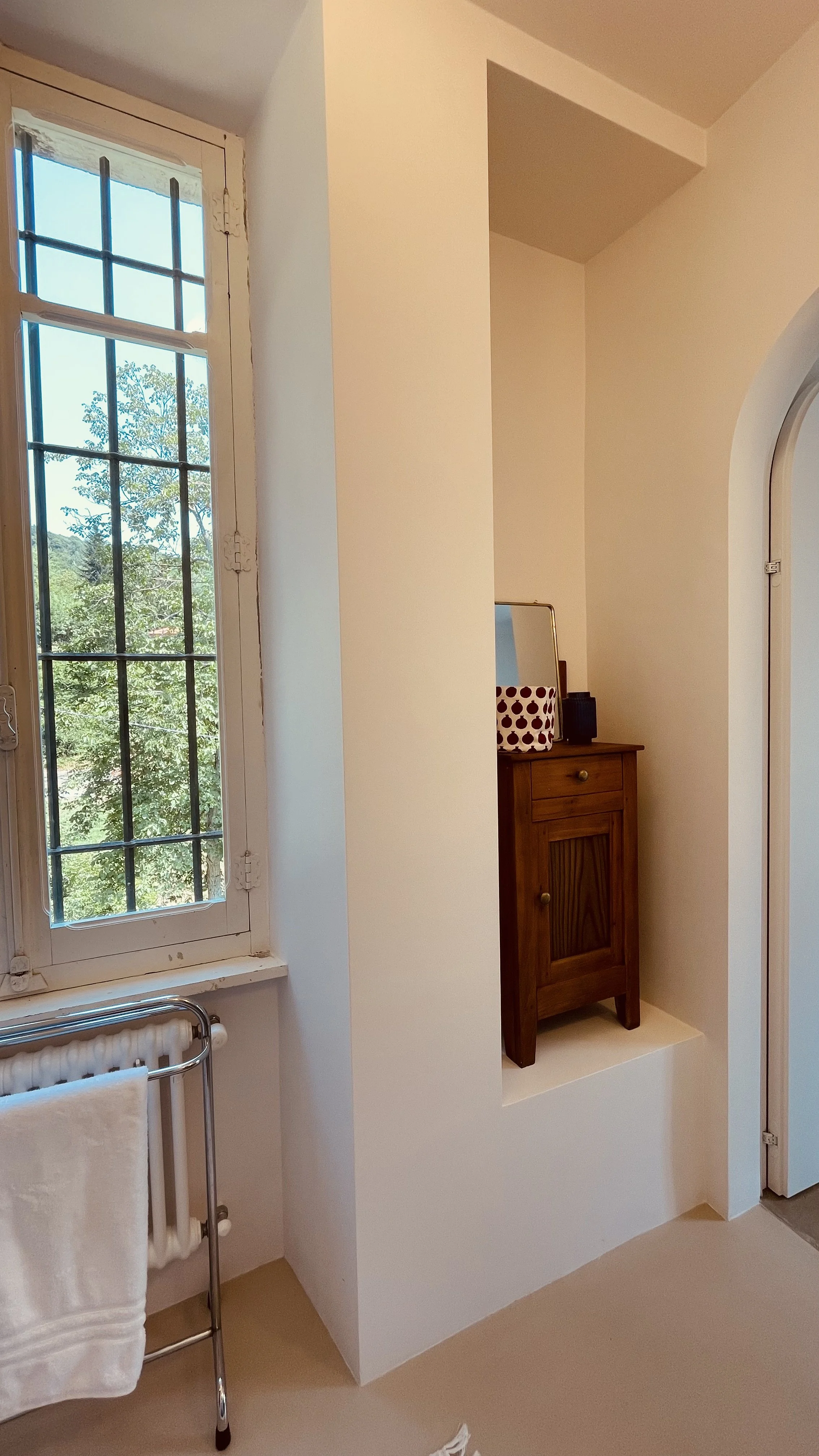 Historic window and antique furniture in the Master Bedroom bathroom at Villa Oberti near Mondovì