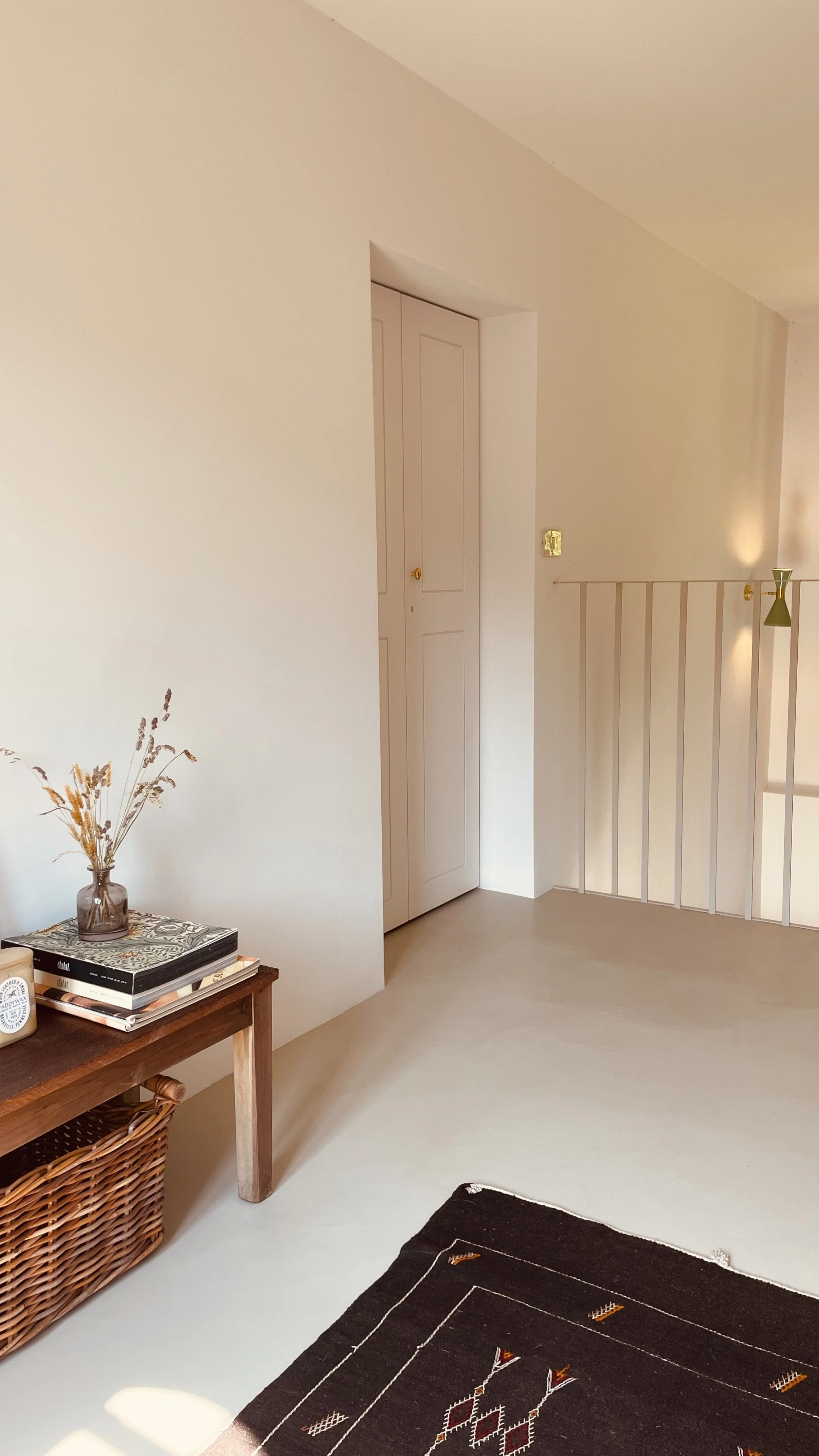 Minimal attic landing with vintage furniture at Villa Oberti, a restored 1912 villa near Mondovì in Piedmont