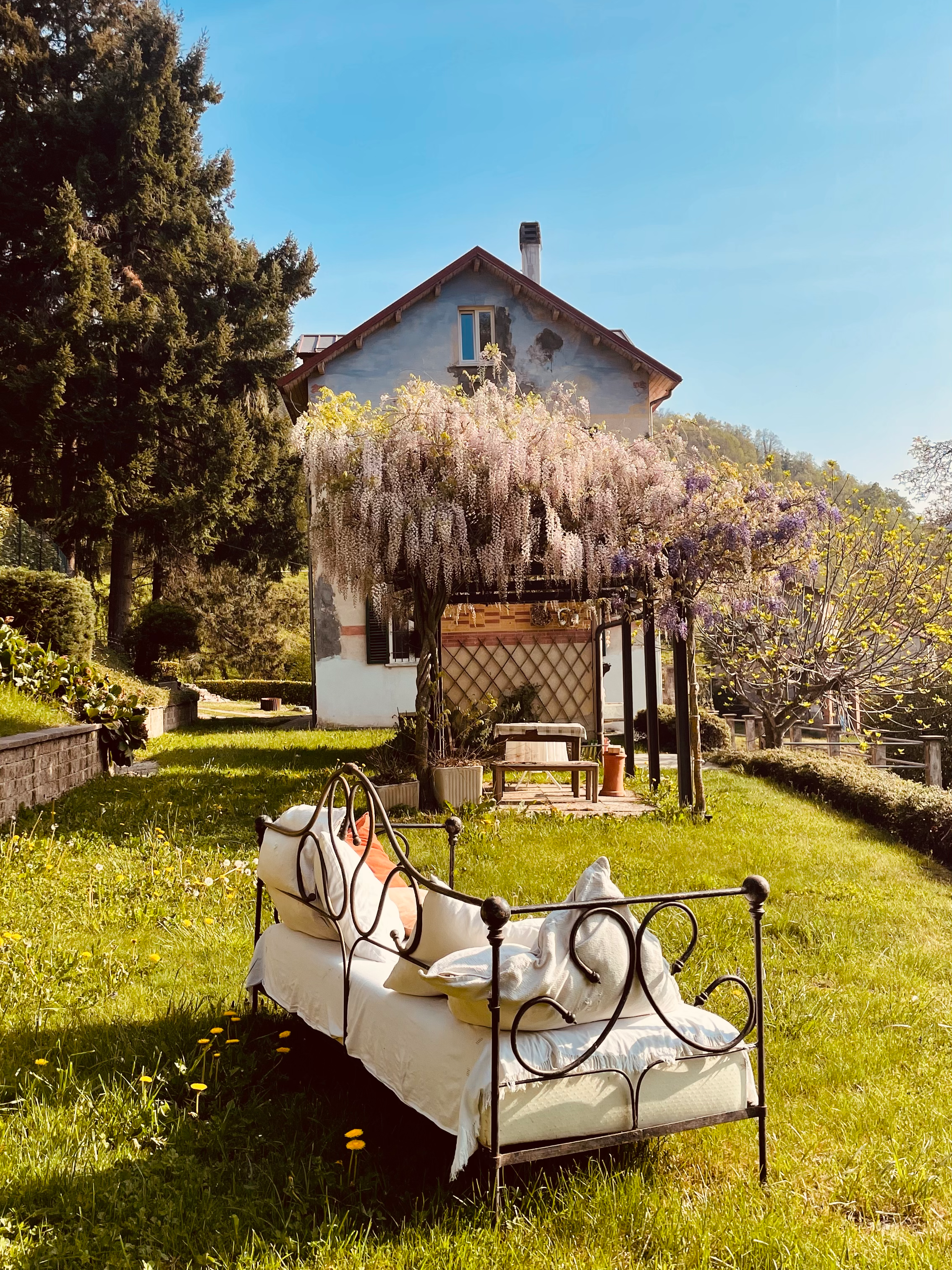 Garden daybed beneath the wisteria at Villa Oberti, a charming private villa near Mondovì in Piedmont