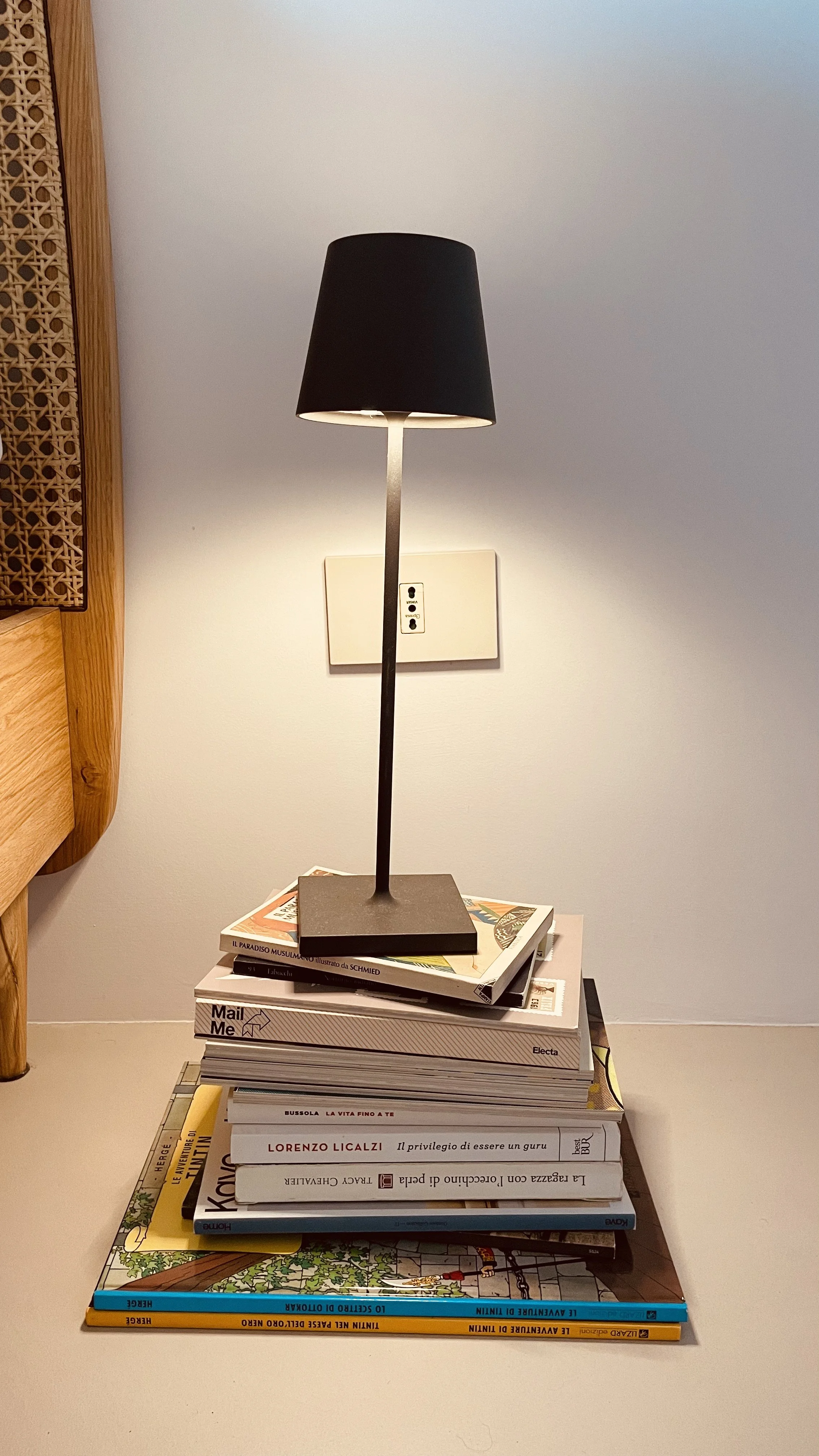 Bedside lamp and design books in the Cielo Suite at Villa Oberti, a refined countryside villa in Piedmont