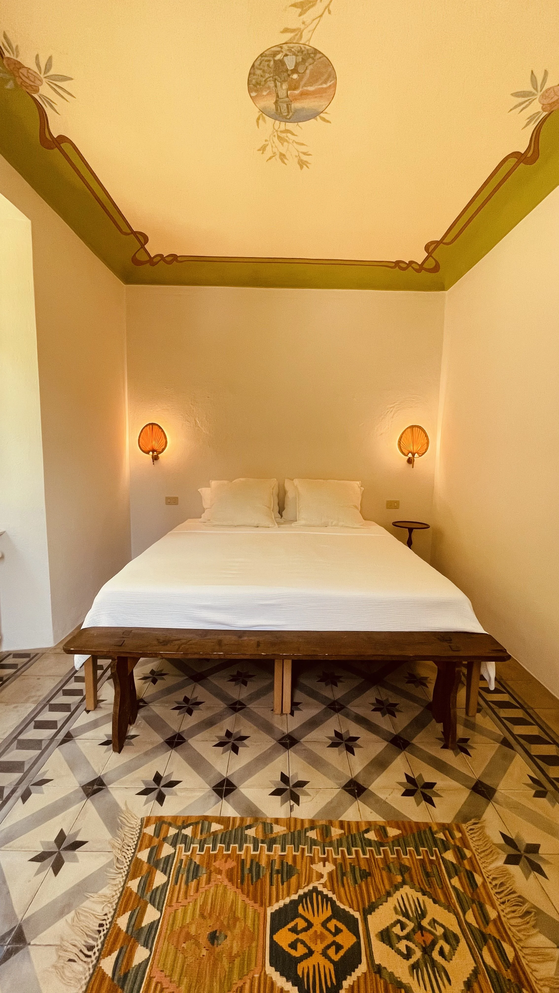 The Fresco Rooms at Villa Oberti with painted ceiling details and original tiled floors, in a historic villa near Mondovì in Piedmont