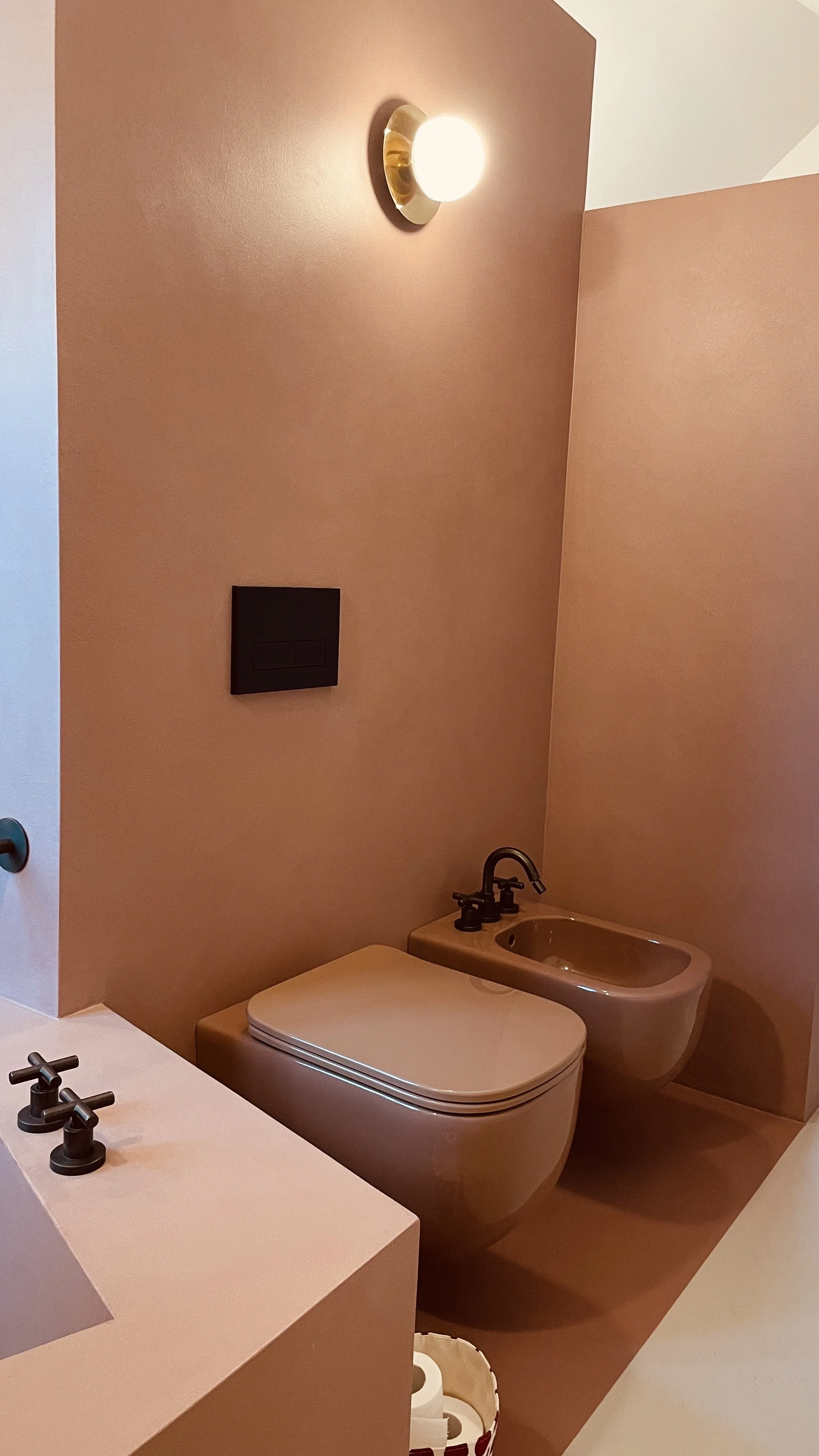 Private bathroom with bidet and terracotta finishes at Villa Oberti, a design-focused villa in Piedmont