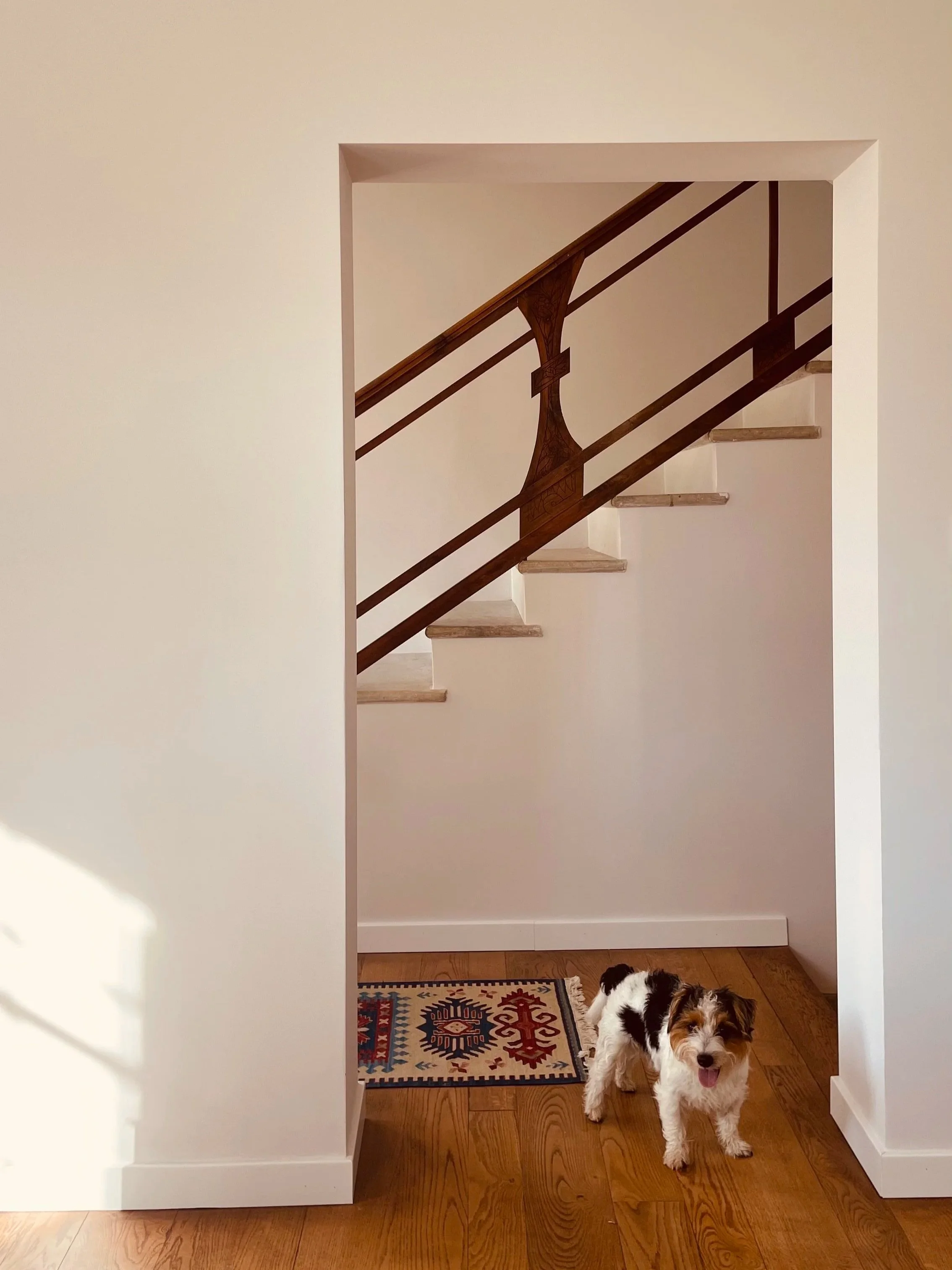 Welcoming interior at Villa Oberti with original staircase and warm country details, in a charming private villa near Mondovì in Piedmont
