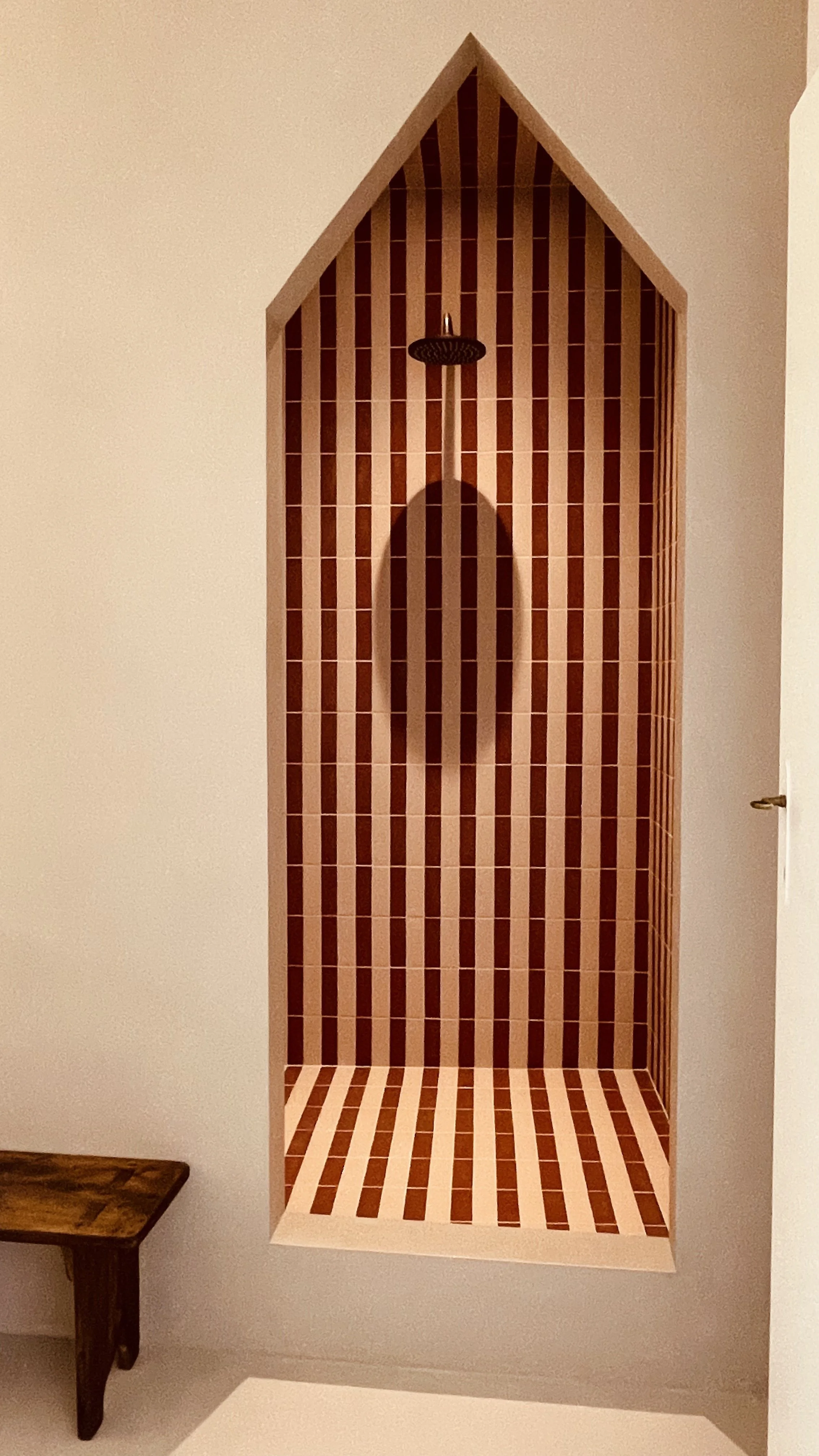 Architectural walk-in shower with terracotta striped tiles at Villa Oberti, a design-led villa near Mondovì in Piedmont