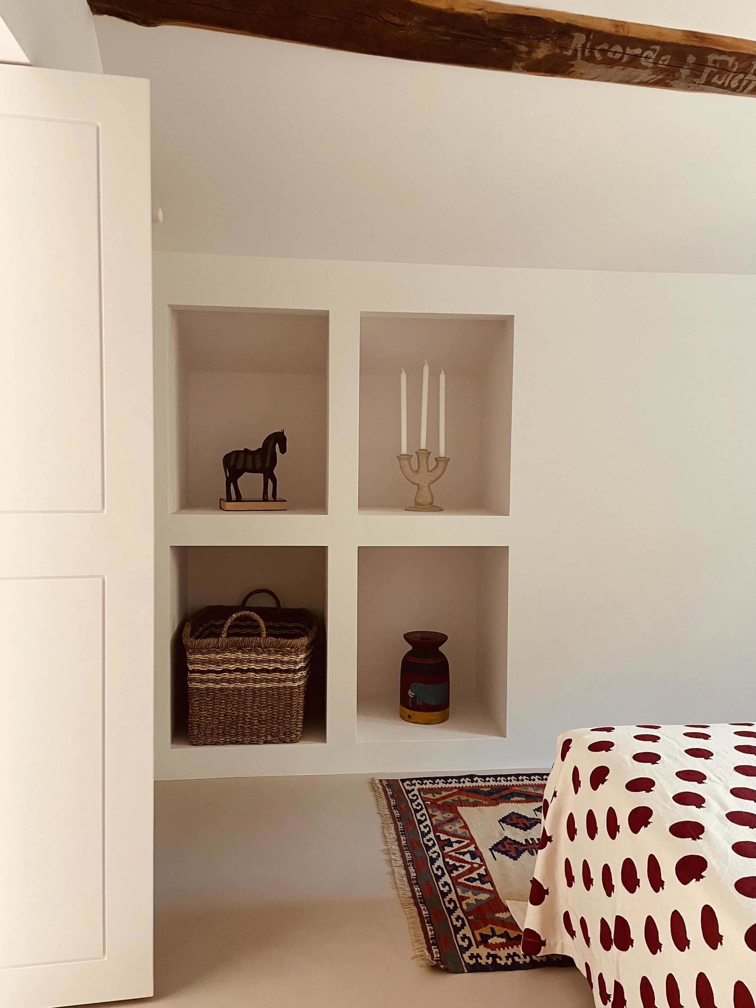 Built-in niches and collected objects in the Cielo Suite at Villa Oberti, a charming countryside stay near Mondovì