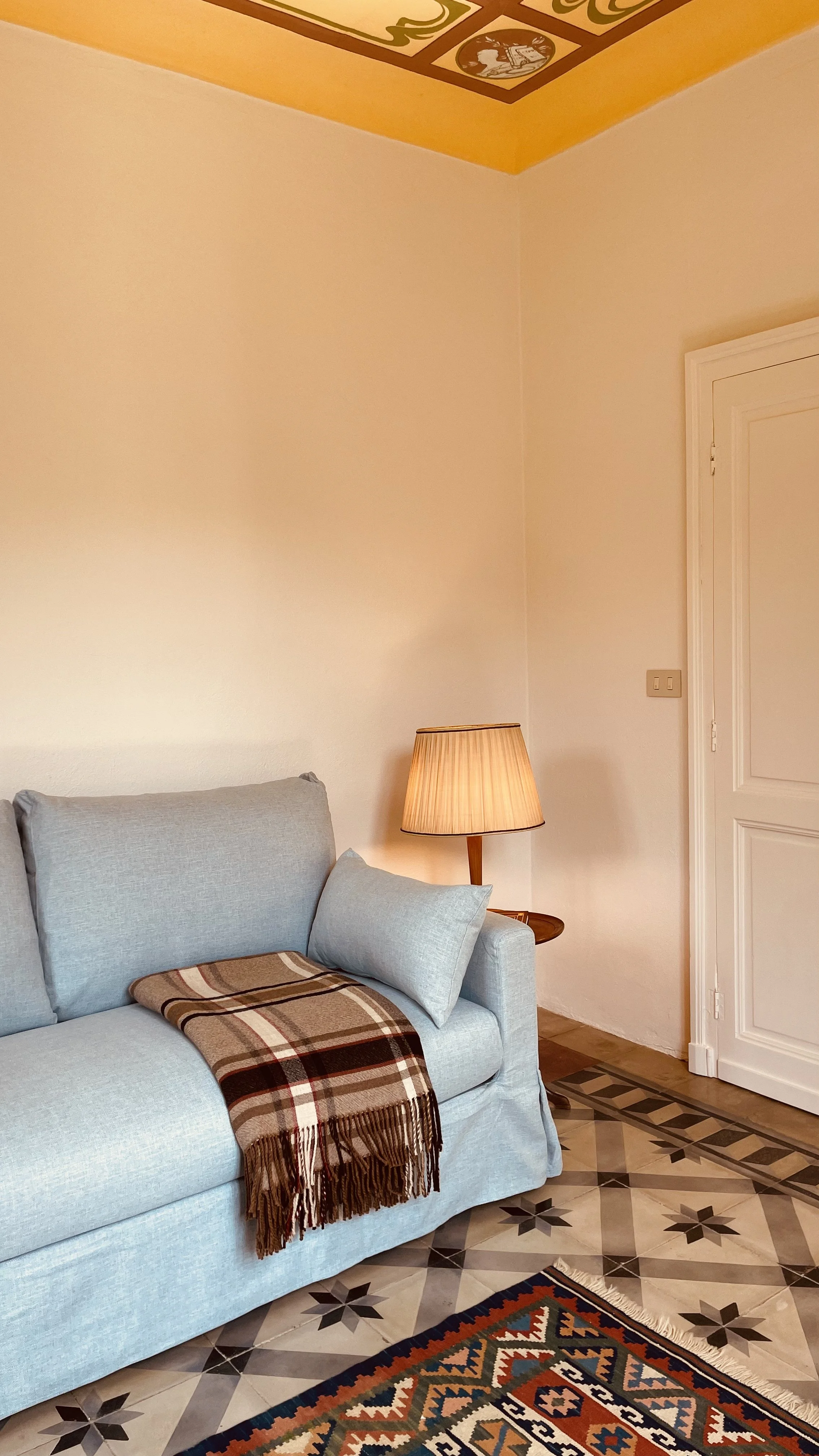 Cosy study corner with blue sofa and vintage lamp at Villa Oberti, a charming private villa in the Piedmont countryside
