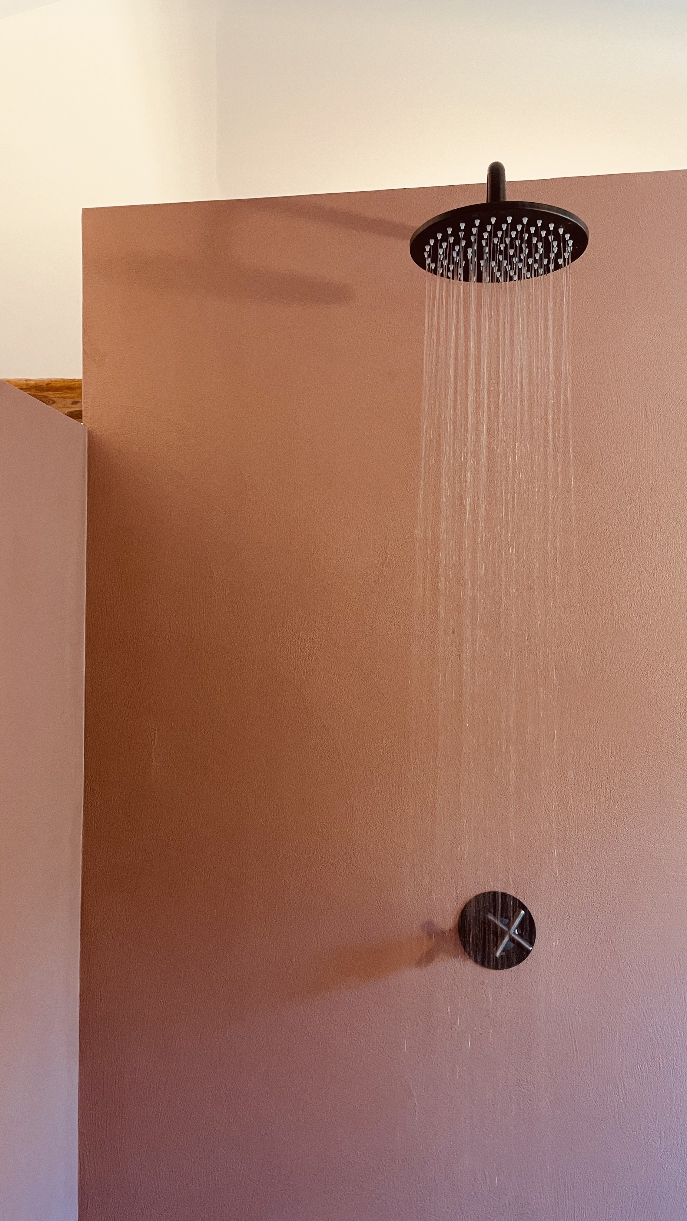 Rain shower in the terracotta bathroom of the Cielo Suite at Villa Oberti, a restored historic villa in Piedmont