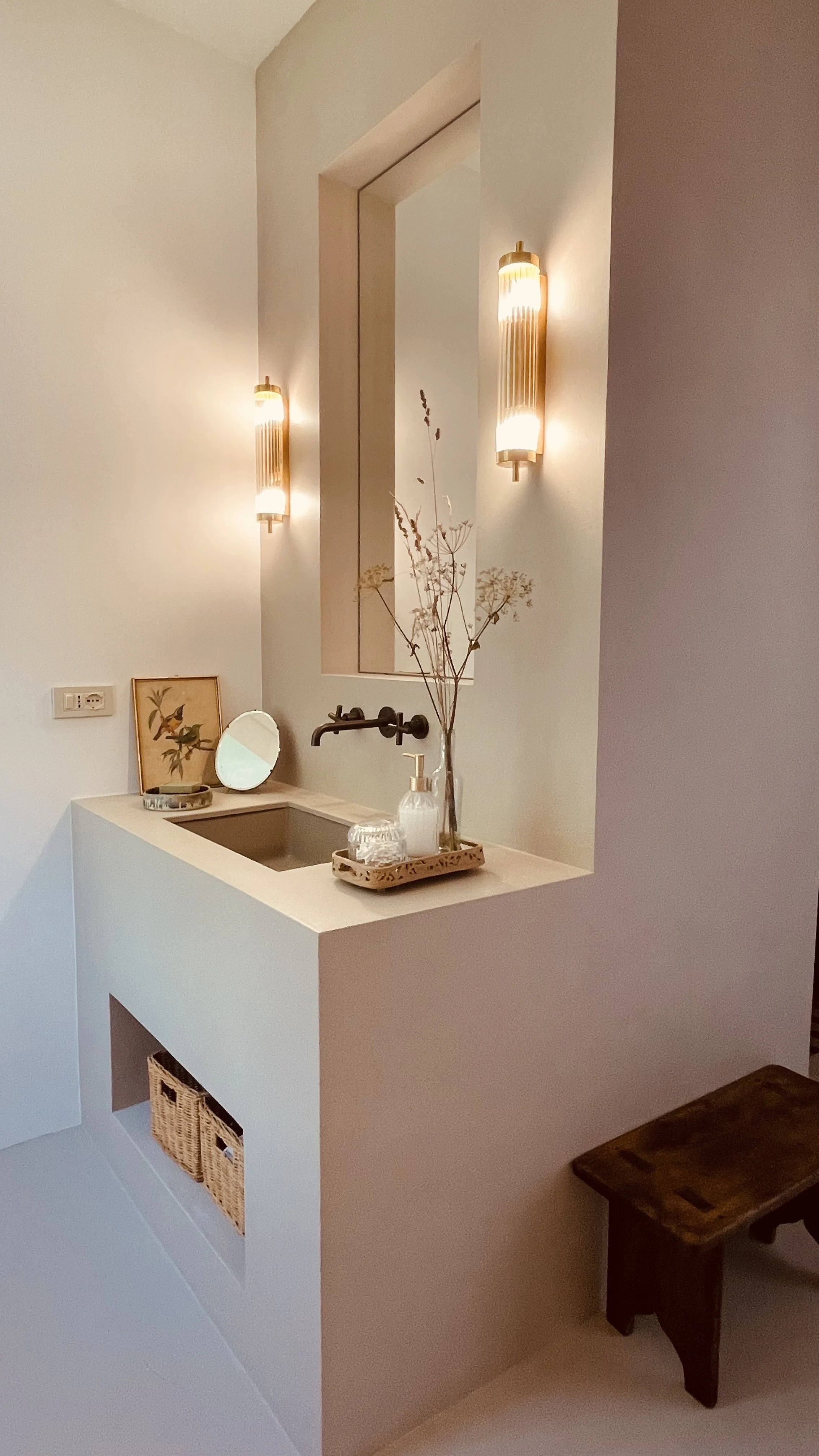 Minimalist bathroom vanity with vintage-inspired lighting at Villa Oberti, a restored private villa near Mondovì