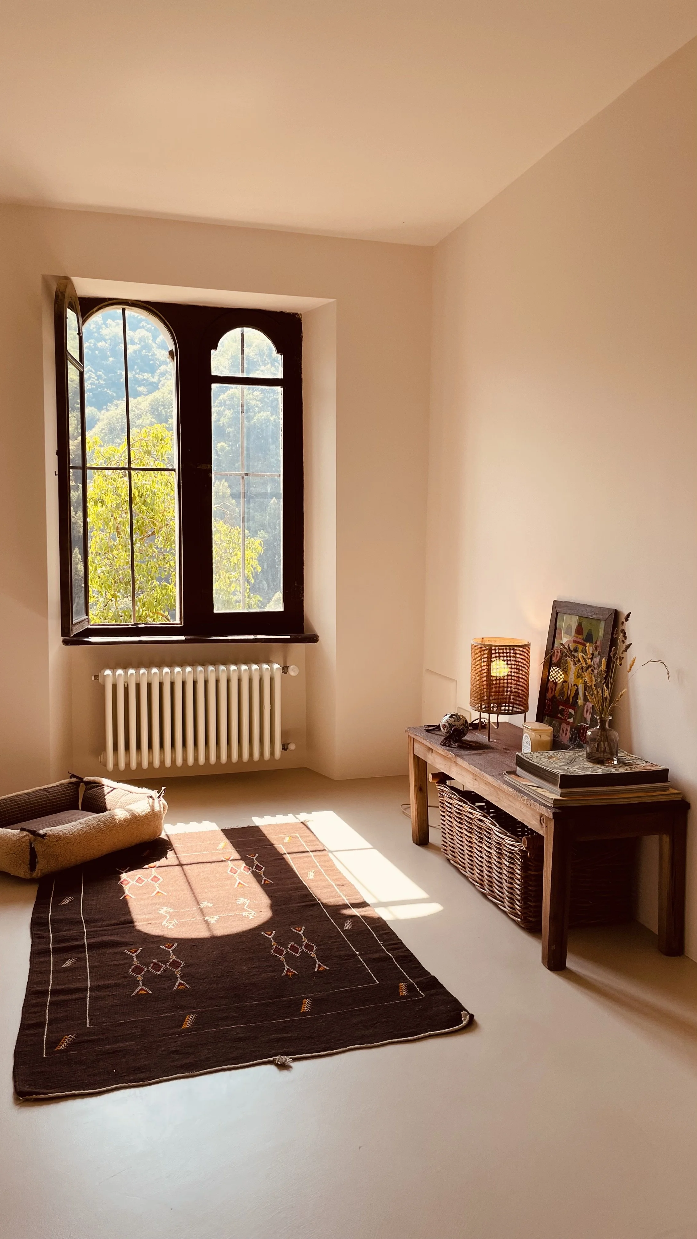 Sunlit reading area with arched window in the Cielo Suite at Villa Oberti, a private villa in the Piedmont countryside