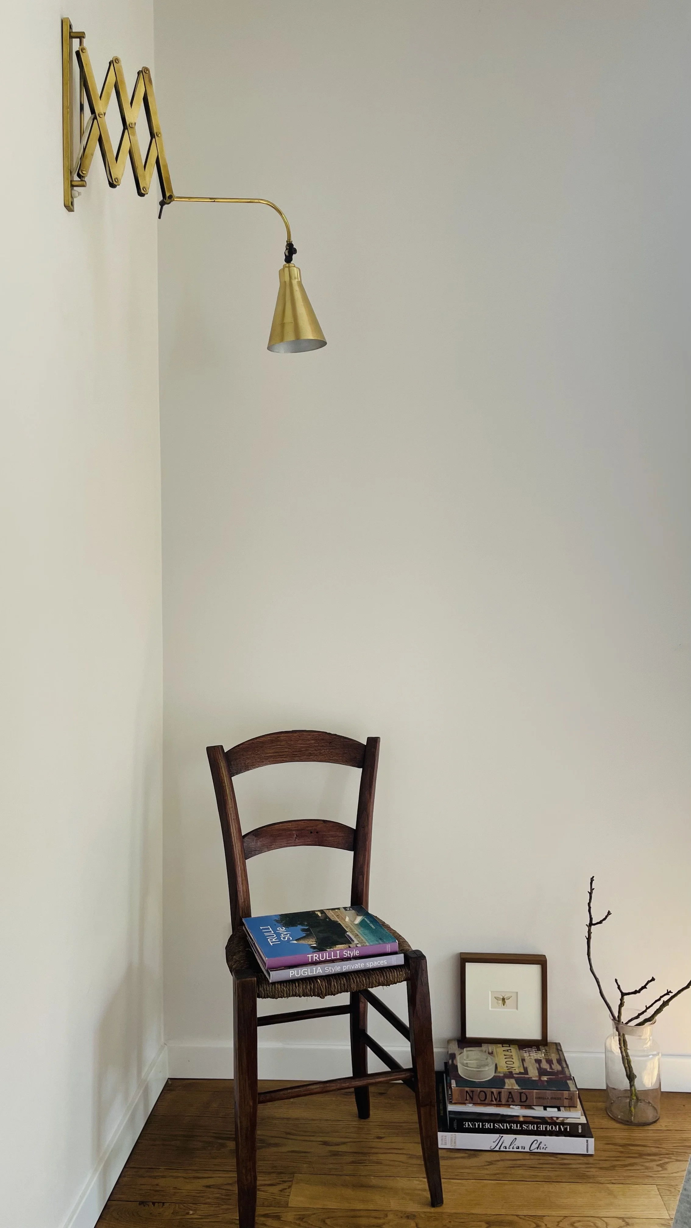 Reading corner with vintage chair, brass lamp and books at Villa Oberti, a historic villa near Mondovì in Piedmont