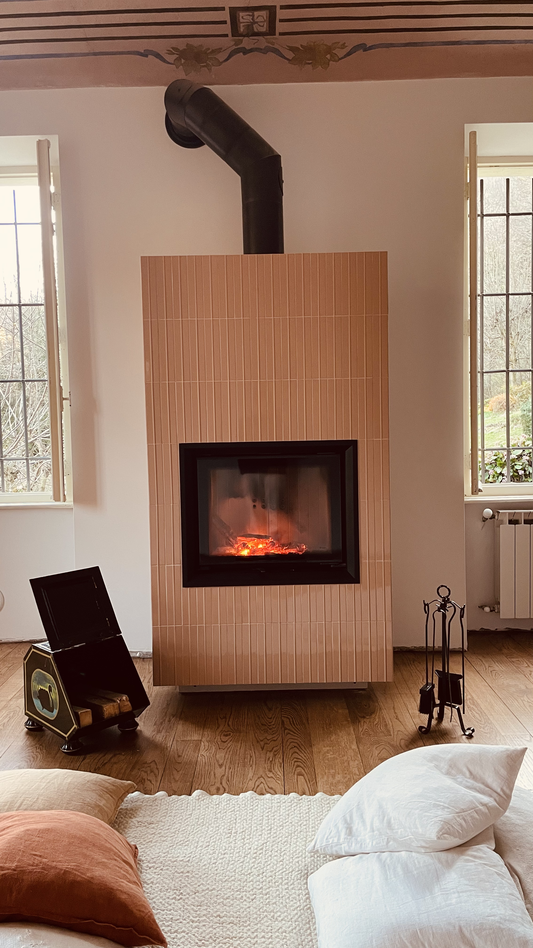 Ceramic fireplace in the living room at Villa Oberti, a restored private villa in the Piedmont countryside