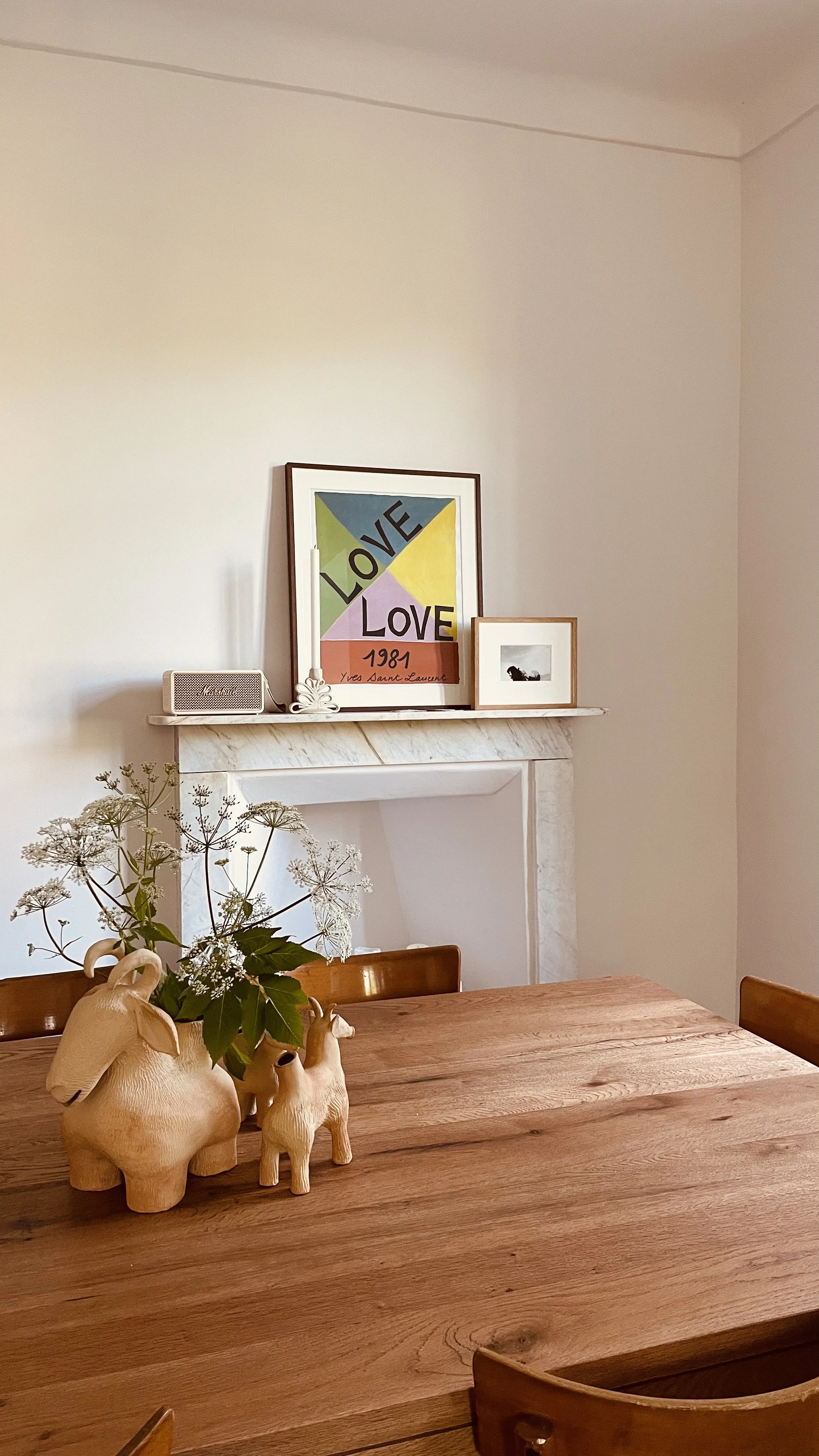 Wooden dining table and collected objects in the kitchen at Villa Oberti, a restored countryside villa in Piedmont