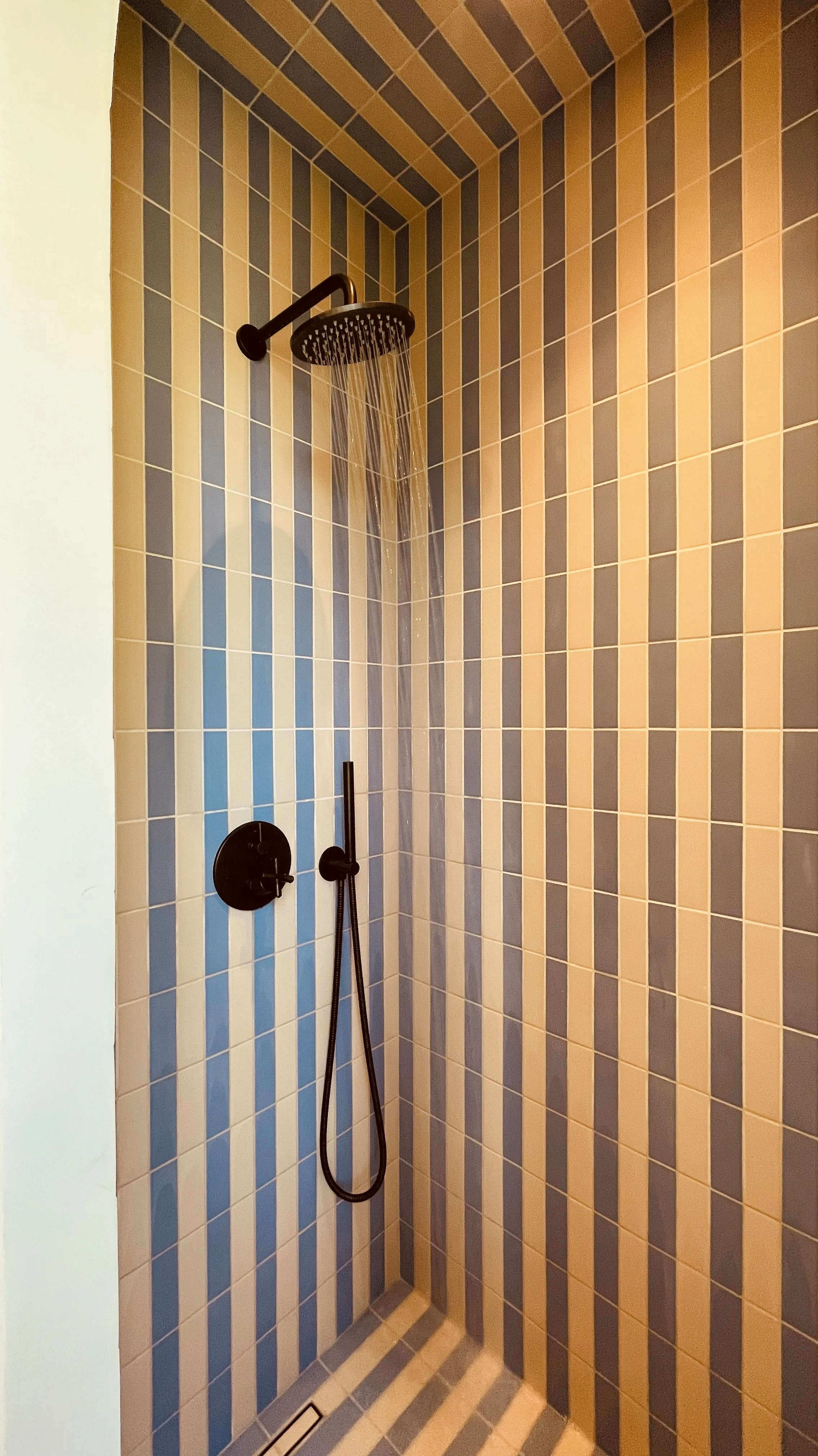 Striped tiled shower in the Master Bedroom bathroom at Villa Oberti, a charming private stay in Piedmont