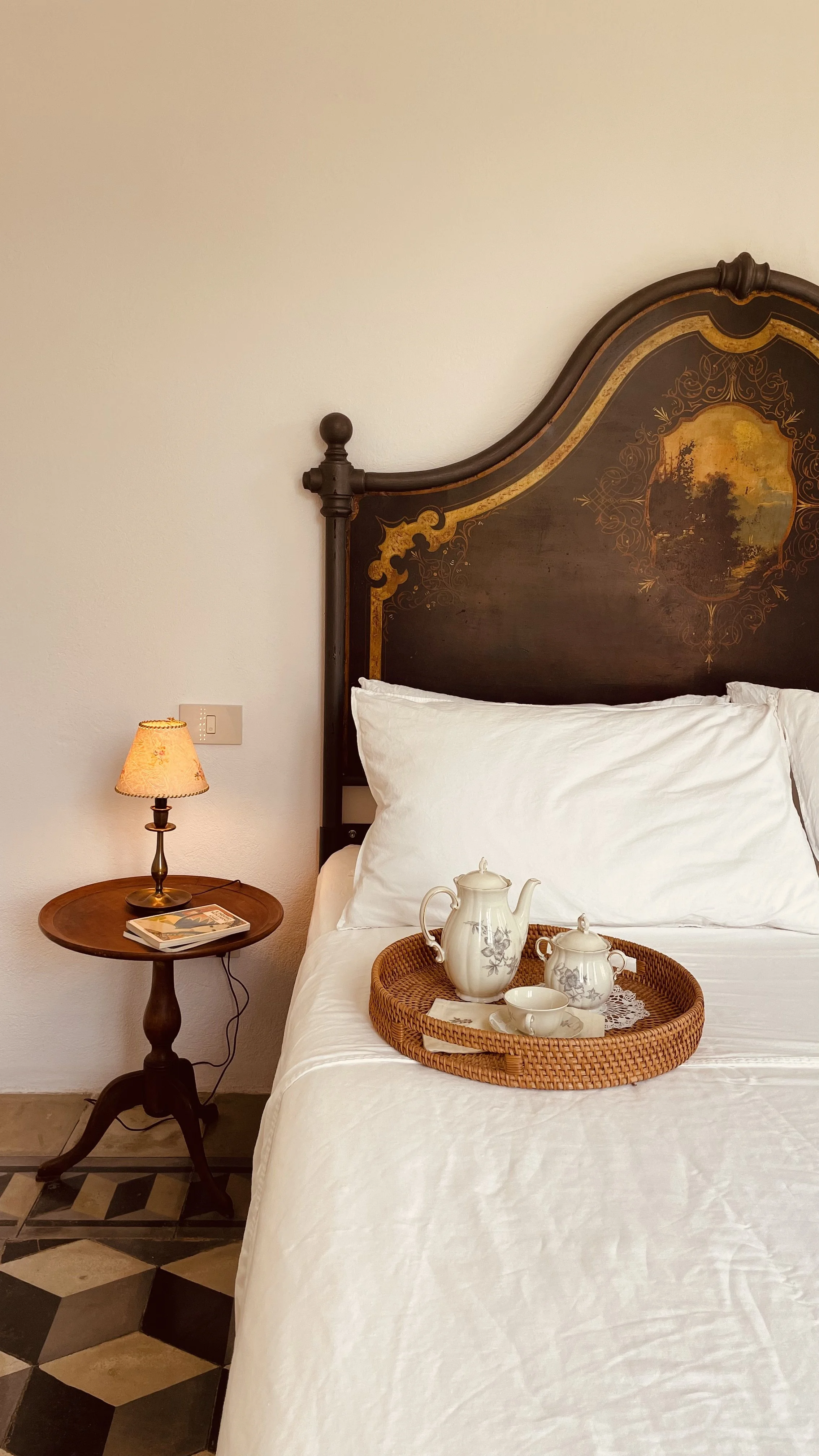 Antique painted headboard and elegant bedroom details at Villa Oberti, a charming countryside villa near Mondovì