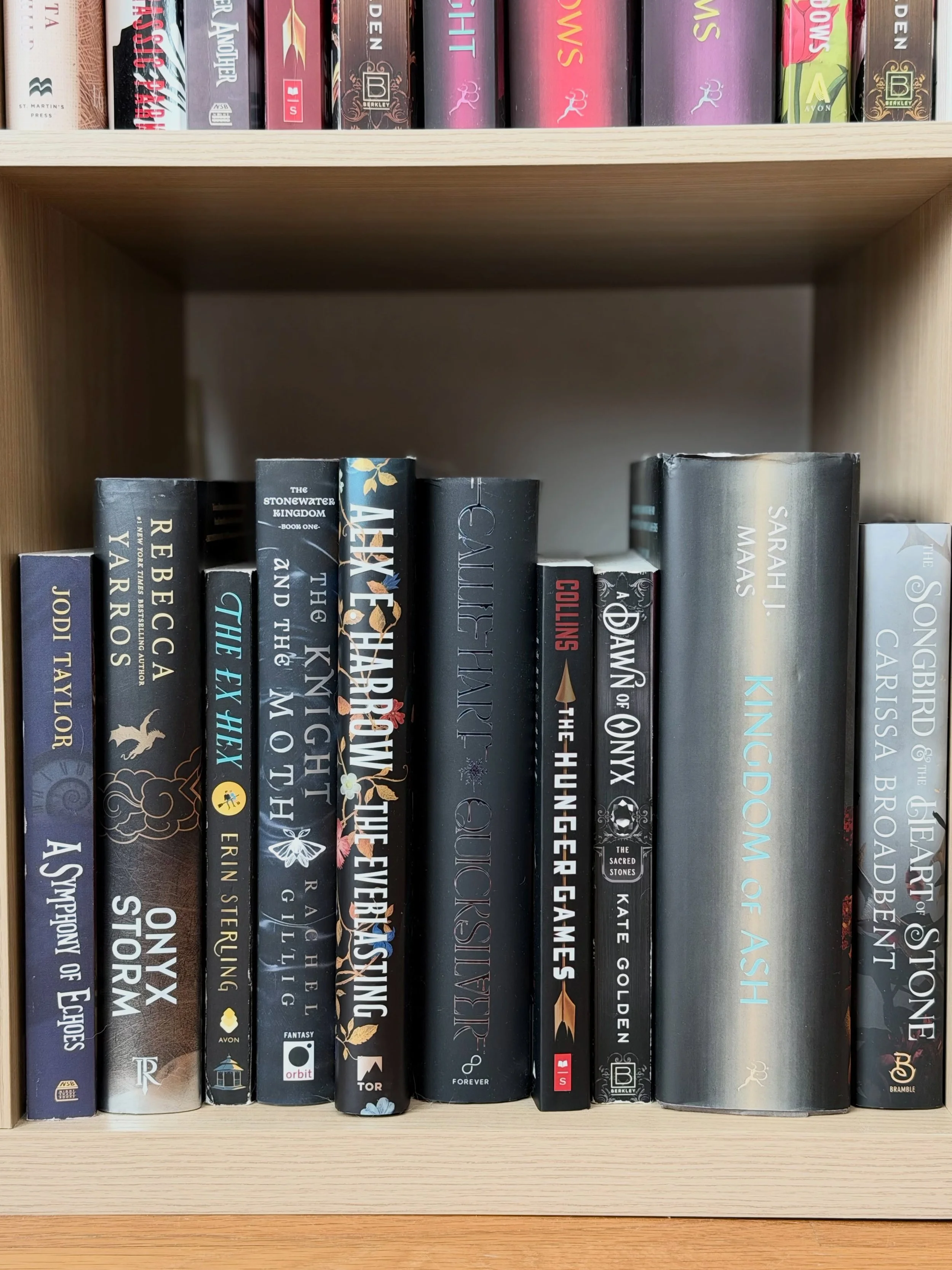 Another snapshot from my bookshelves... all different kinds of fantasy subgenres on the black &amp; gray shelf. 🖤

spot The Knight and the Moth by @rmgillig?  It was my favorite fantasy read last year, and I&rsquo;m counting down the days until I ca