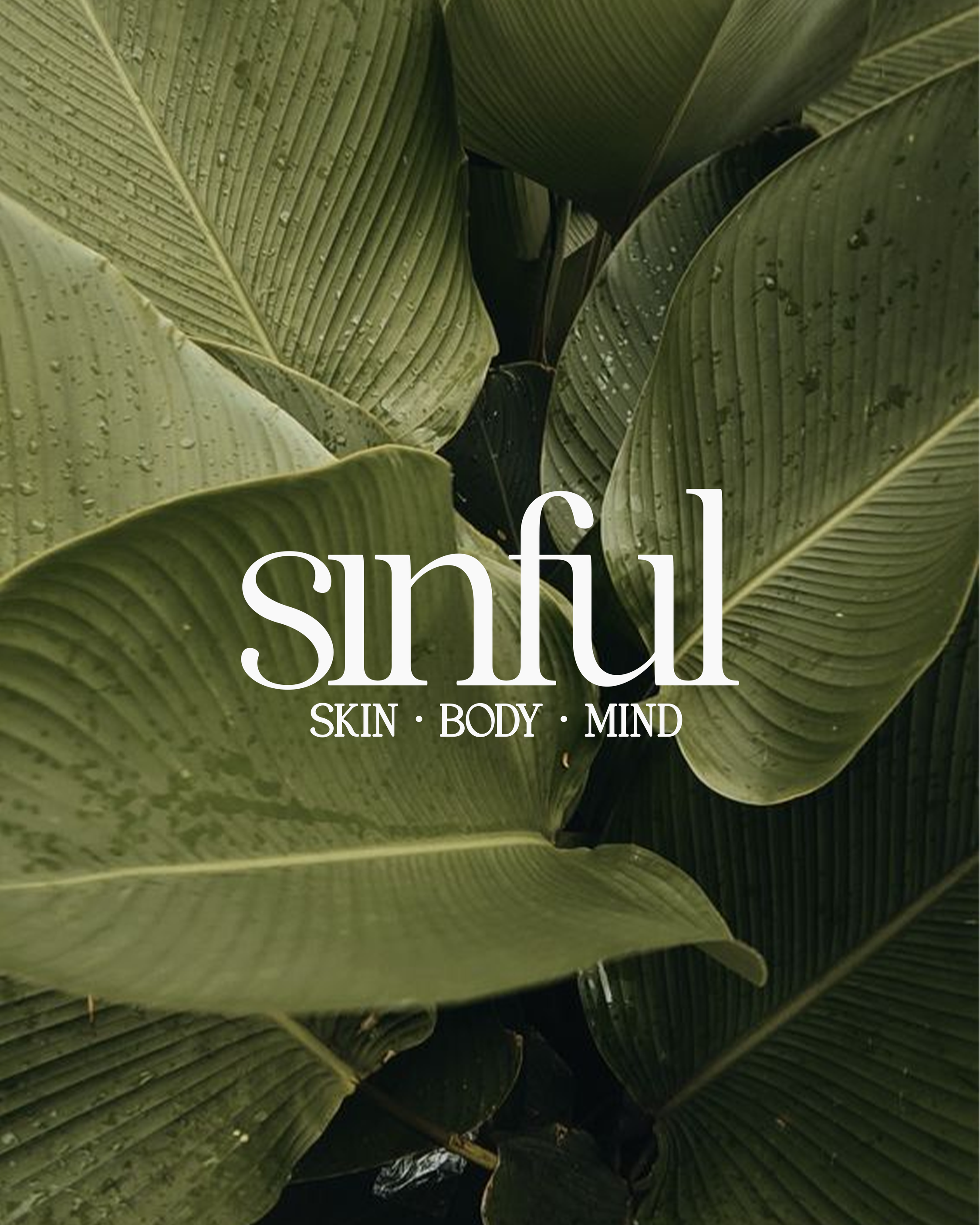 Close-up of green tropical leaves with water droplets, with text overlay reading 'sinful SKIN · BODY · MIND'.