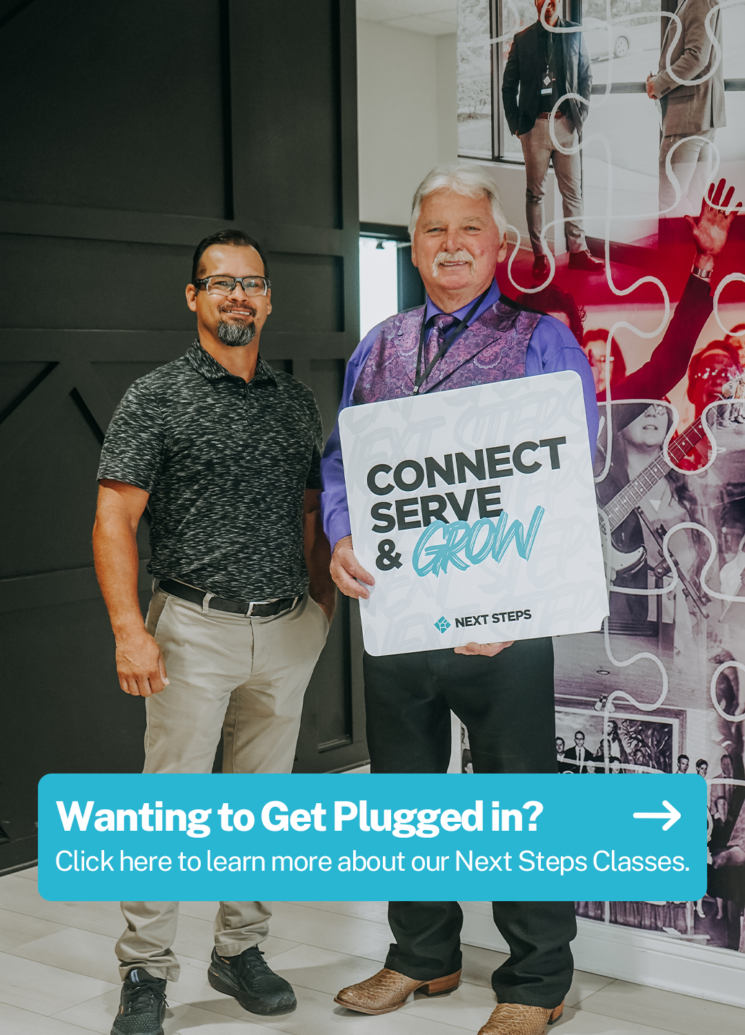 Two men standing indoors, one holding a sign that says 'Connect, Serve & Grow' from Next Steps, with a colorful mural in the background and a banner below that reads 'Wanting to Get Plugged in? Click here to learn more about our Next Steps Classes.'